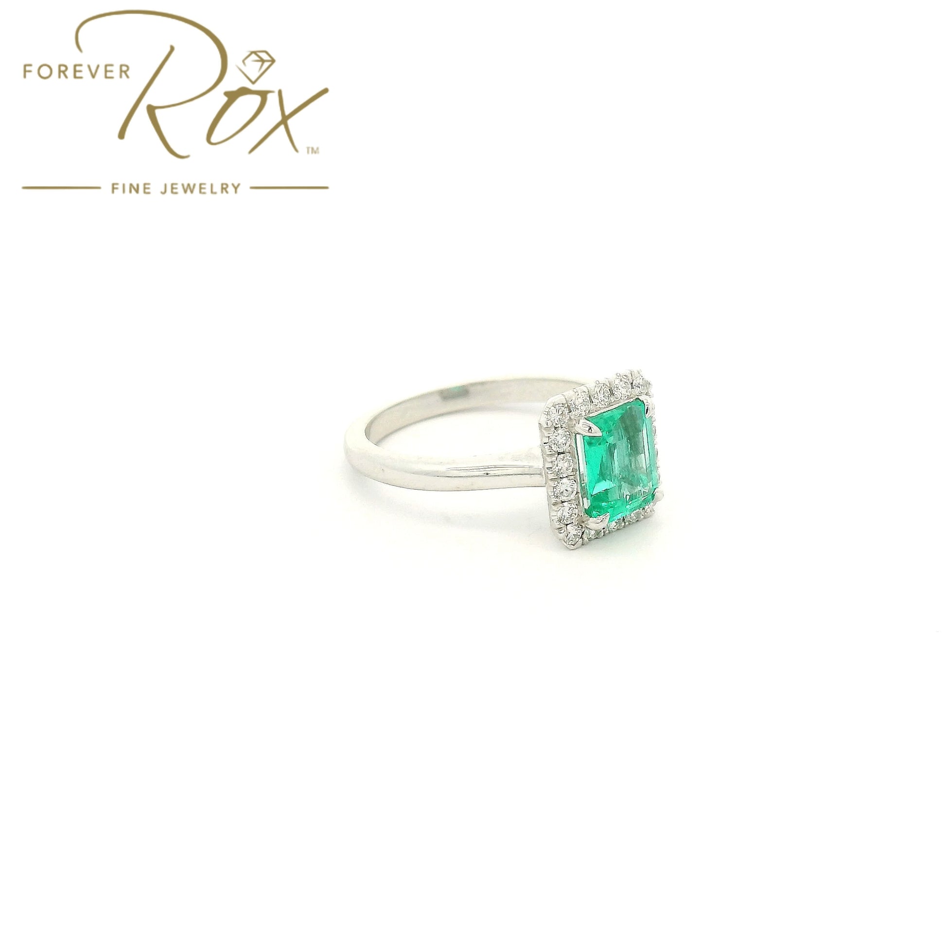 Custom 14k white gold ring featuring a 1.05ct emerald-cut Colombian emerald with a 0.22ctw diamond halo by Forever Rox Fine Jewelry, Lake Tahoes Best Jewelry Store