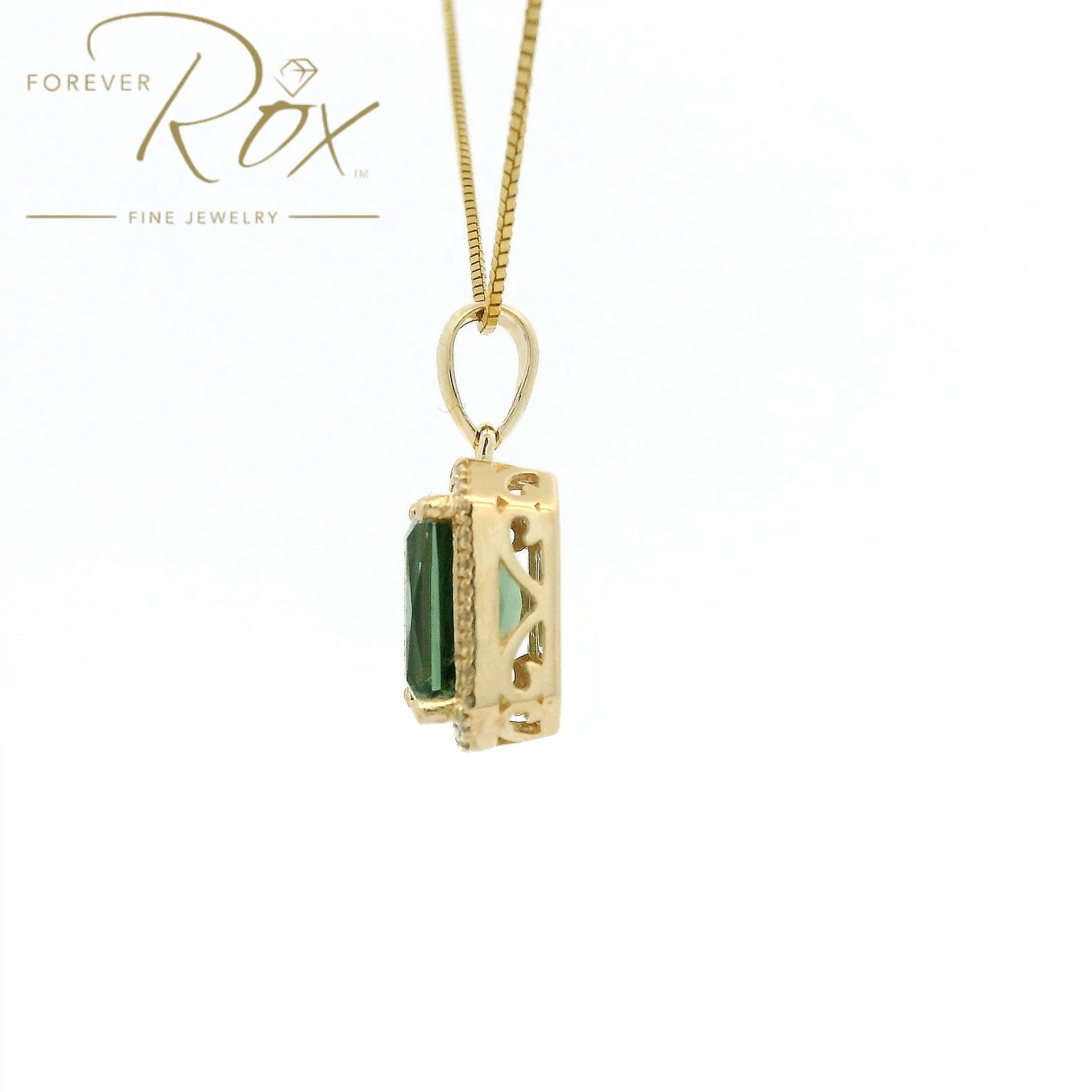 A Yellow Gold Pendant with a prong set emerald cut natural Mint Tourmaline in the center with a halow of diamonds at Forever Rox Fine Jewelry, Lake Tahoes Best Jewelry Store
