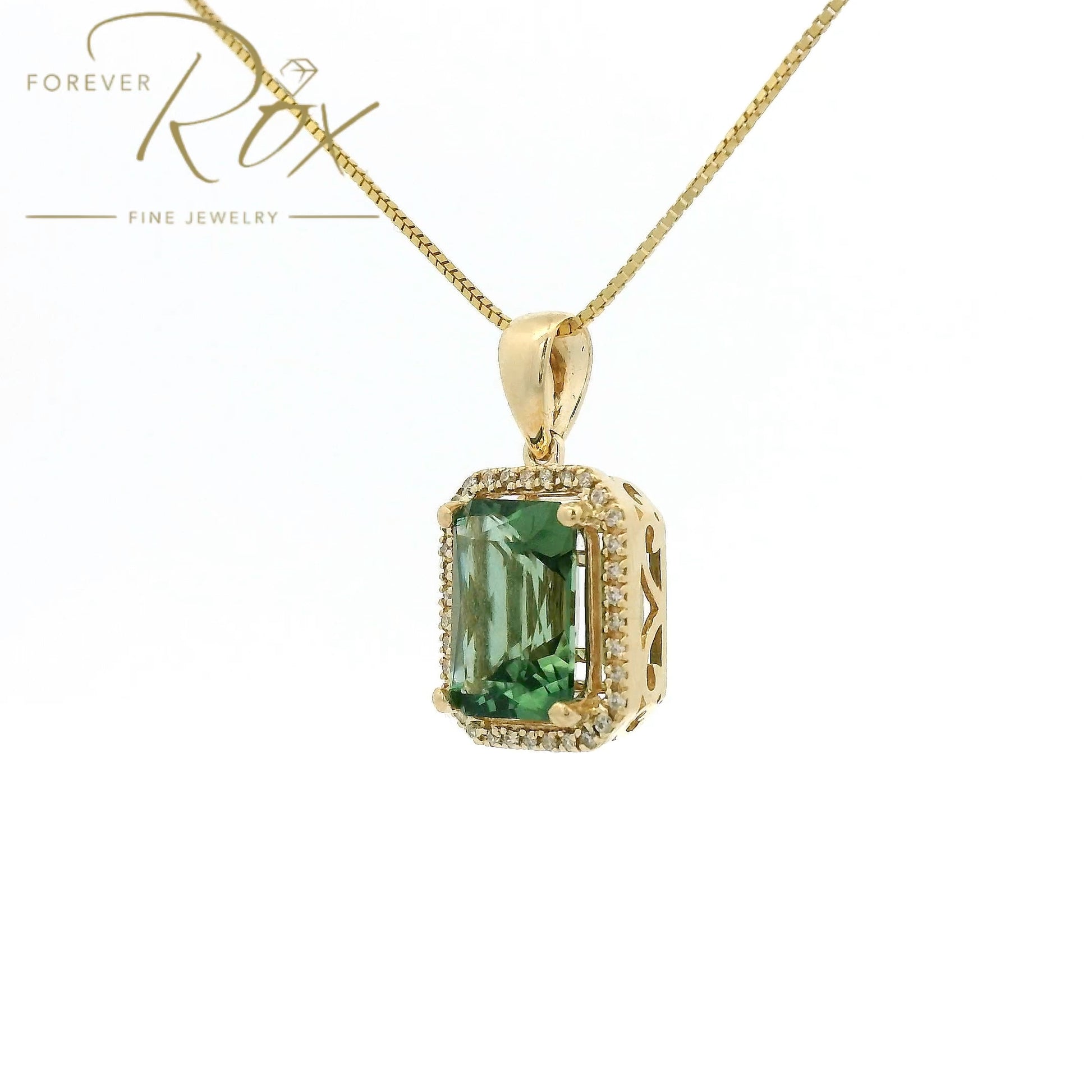 A Yellow Gold Pendant with a prong set emerald cut natural Mint Tourmaline in the center with a halow of diamonds at Forever Rox Fine Jewelry, Lake Tahoes Best Jewelry Store
