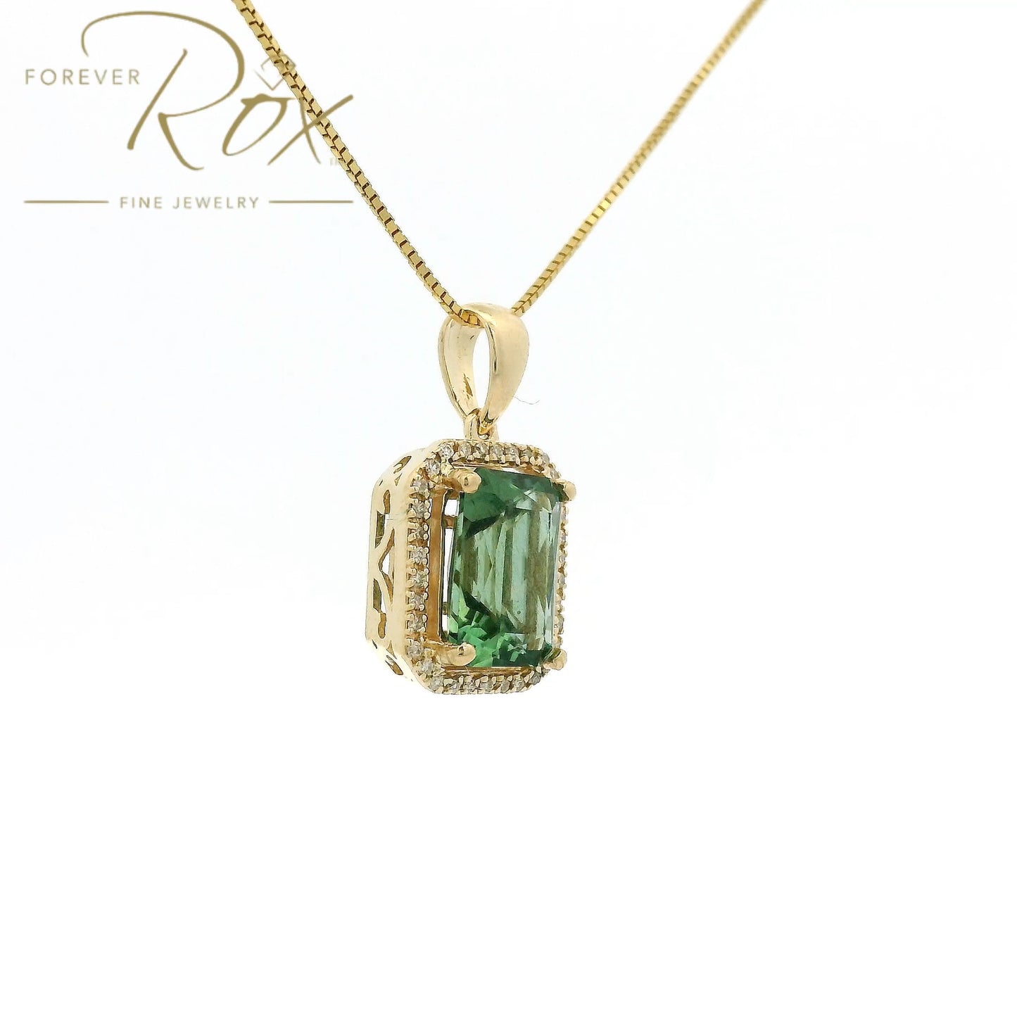 A Yellow Gold Pendant with a prong set emerald cut natural Mint Tourmaline in the center with a halow of diamonds at Forever Rox Fine Jewelry, Lake Tahoes Best Jewelry Store