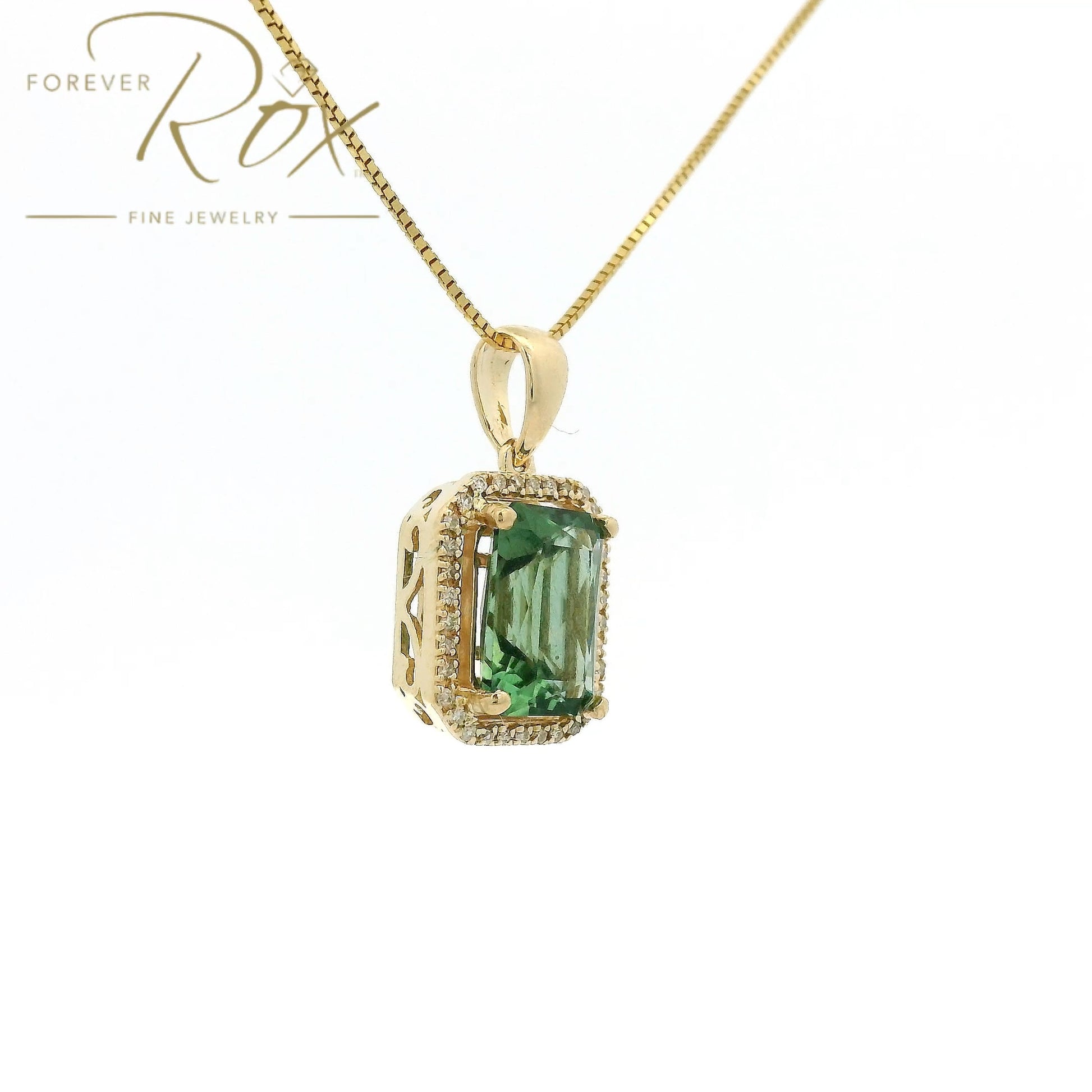 A Yellow Gold Pendant with a prong set emerald cut natural Mint Tourmaline in the center with a halow of diamonds at Forever Rox Fine Jewelry, Lake Tahoes Best Jewelry Store