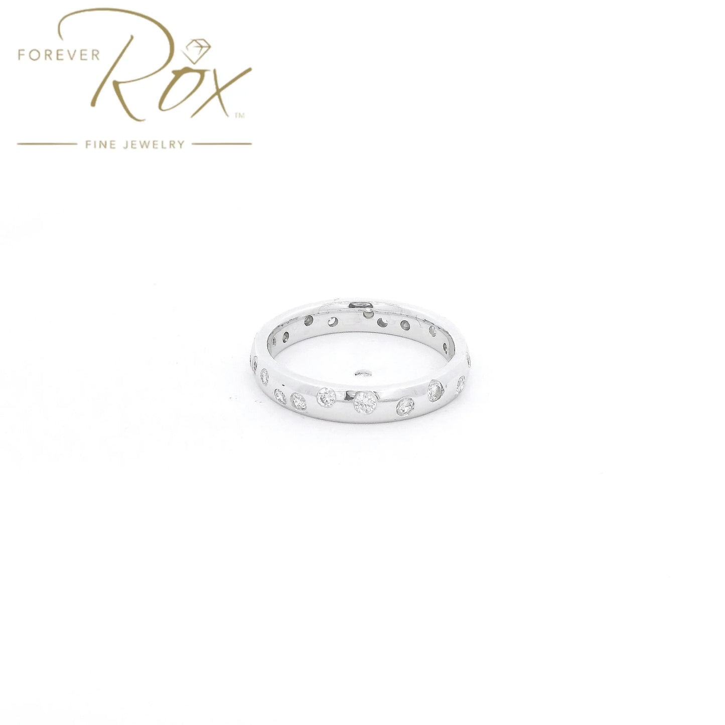 This custom flush-set diamond scatter band is crafted in 14k white gold and features brilliant round diamonds thoughtfully spaced around the band in a modern scattered design. The flush-set construction creates a sleek, low-profile look while allowing each diamond to sparkle from within the metal. Elegant, comfortable, and timeless, this custom piece is perfect as a wedding band, stacking ring, or everyday statement.
