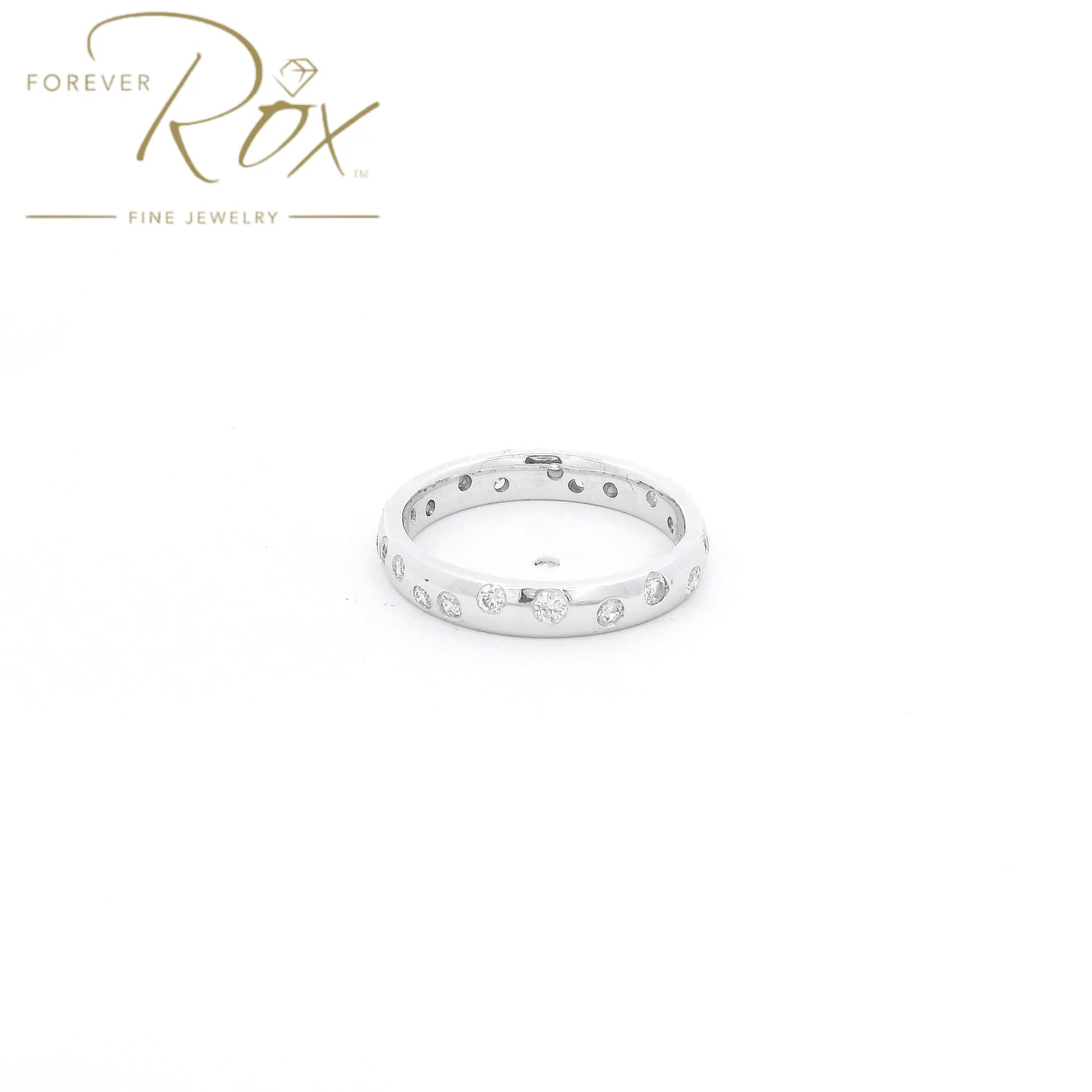 This custom flush-set diamond scatter band is crafted in 14k white gold and features brilliant round diamonds thoughtfully spaced around the band in a modern scattered design. The flush-set construction creates a sleek, low-profile look while allowing each diamond to sparkle from within the metal. Elegant, comfortable, and timeless, this custom piece is perfect as a wedding band, stacking ring, or everyday statement.