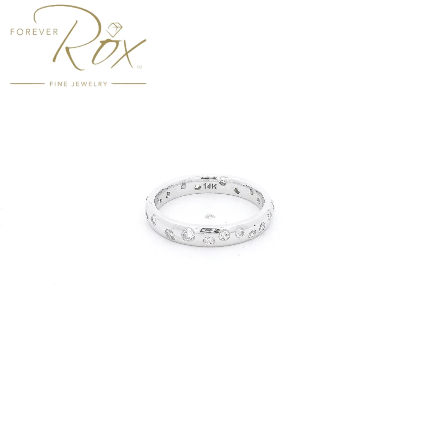 This custom flush-set diamond scatter band is crafted in 14k white gold and features brilliant round diamonds thoughtfully spaced around the band in a modern scattered design. The flush-set construction creates a sleek, low-profile look while allowing each diamond to sparkle from within the metal. Elegant, comfortable, and timeless, this custom piece is perfect as a wedding band, stacking ring, or everyday statement.