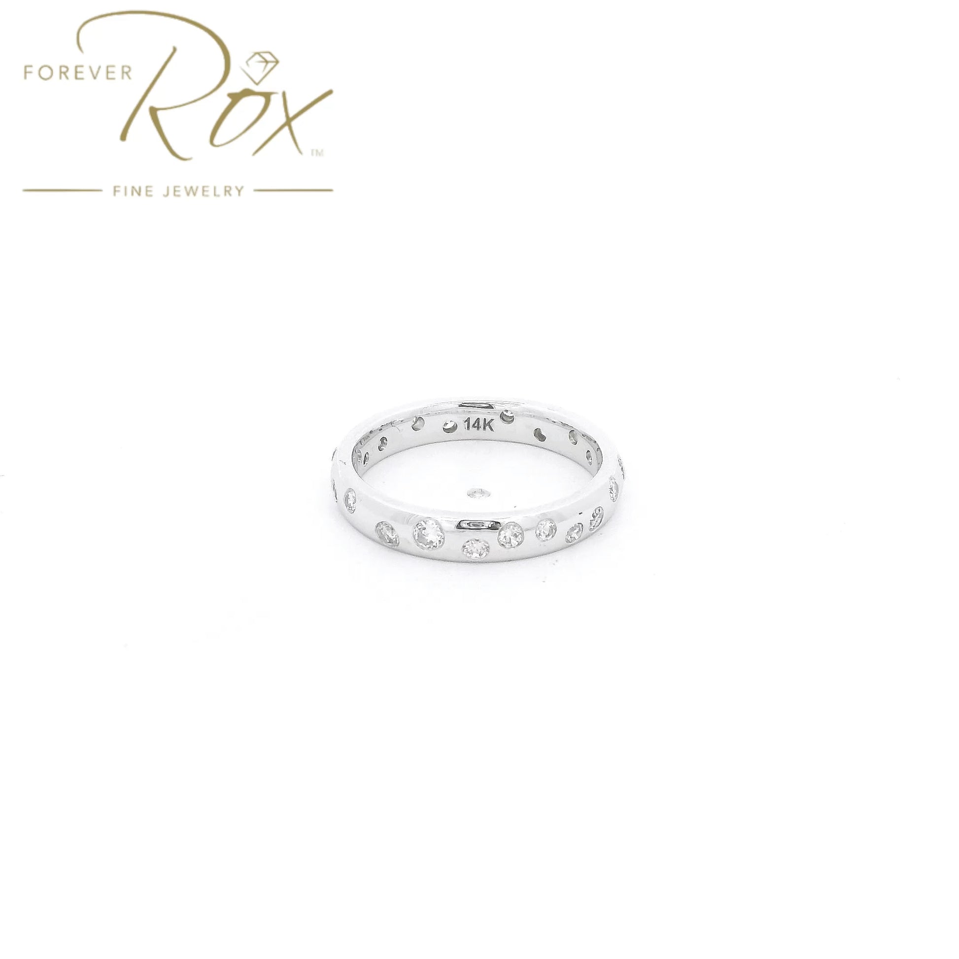 This custom flush-set diamond scatter band is crafted in 14k white gold and features brilliant round diamonds thoughtfully spaced around the band in a modern scattered design. The flush-set construction creates a sleek, low-profile look while allowing each diamond to sparkle from within the metal. Elegant, comfortable, and timeless, this custom piece is perfect as a wedding band, stacking ring, or everyday statement.