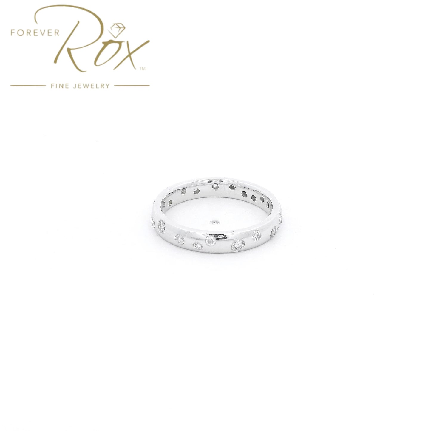 This custom flush-set diamond scatter band is crafted in 14k white gold and features brilliant round diamonds thoughtfully spaced around the band in a modern scattered design. The flush-set construction creates a sleek, low-profile look while allowing each diamond to sparkle from within the metal. Elegant, comfortable, and timeless, this custom piece is perfect as a wedding band, stacking ring, or everyday statement.