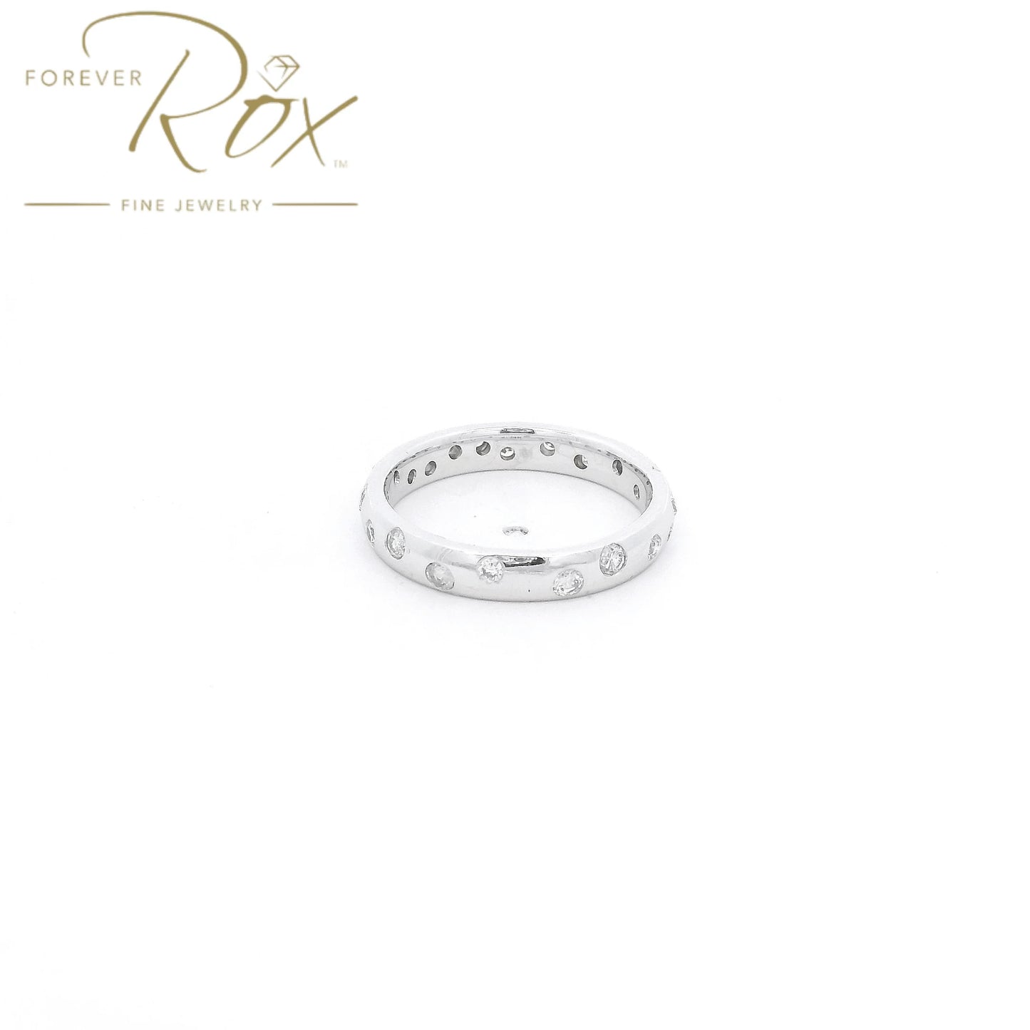 This custom flush-set diamond scatter band is crafted in 14k white gold and features brilliant round diamonds thoughtfully spaced around the band in a modern scattered design. The flush-set construction creates a sleek, low-profile look while allowing each diamond to sparkle from within the metal. Elegant, comfortable, and timeless, this custom piece is perfect as a wedding band, stacking ring, or everyday statement.