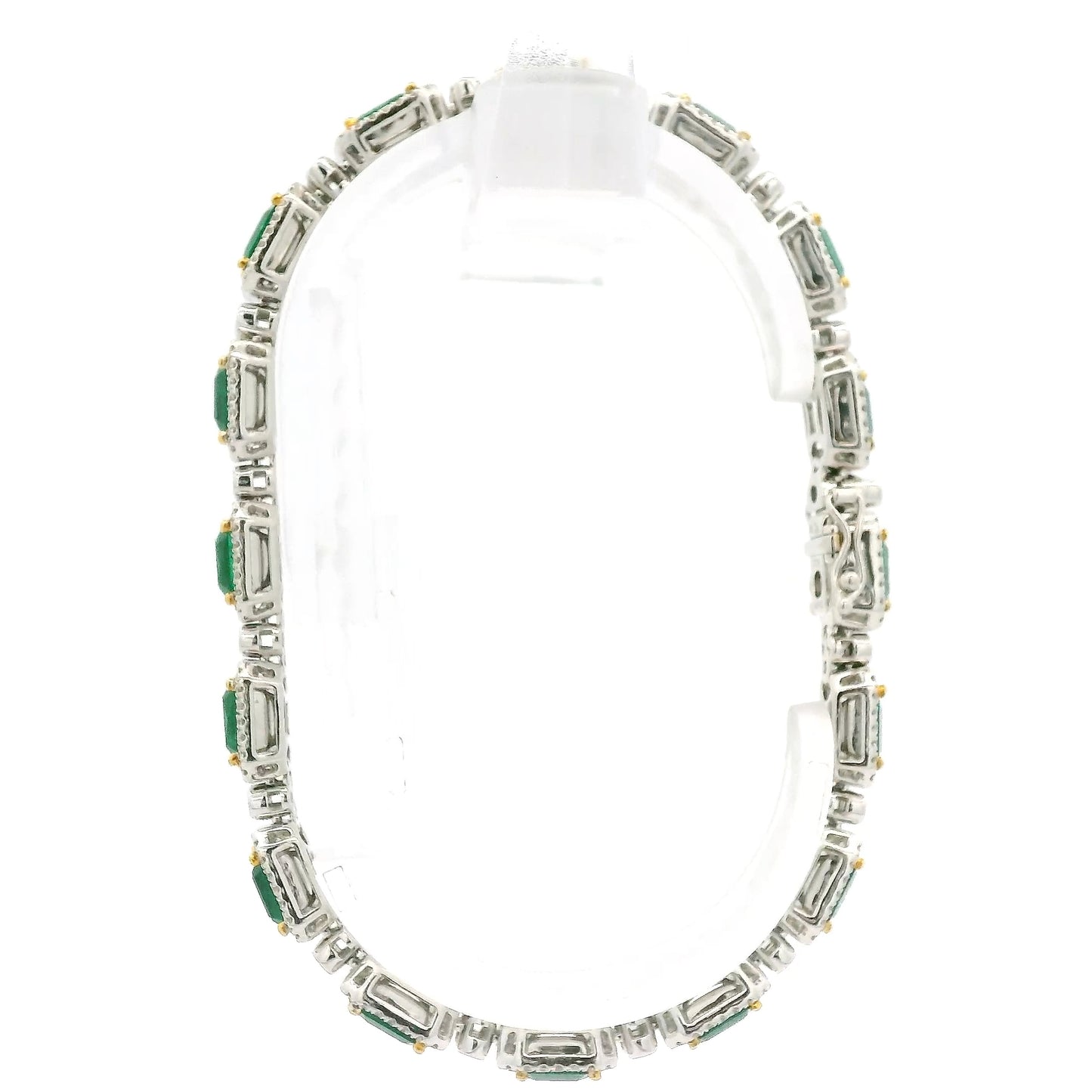 A White Gold Bracelet with prong set emerald cut natural Emeralds in the center with a diamond halo and diamonds between each link at Forever Rox Fine Jewelry, Lake Tahoes Best Jewelry Store