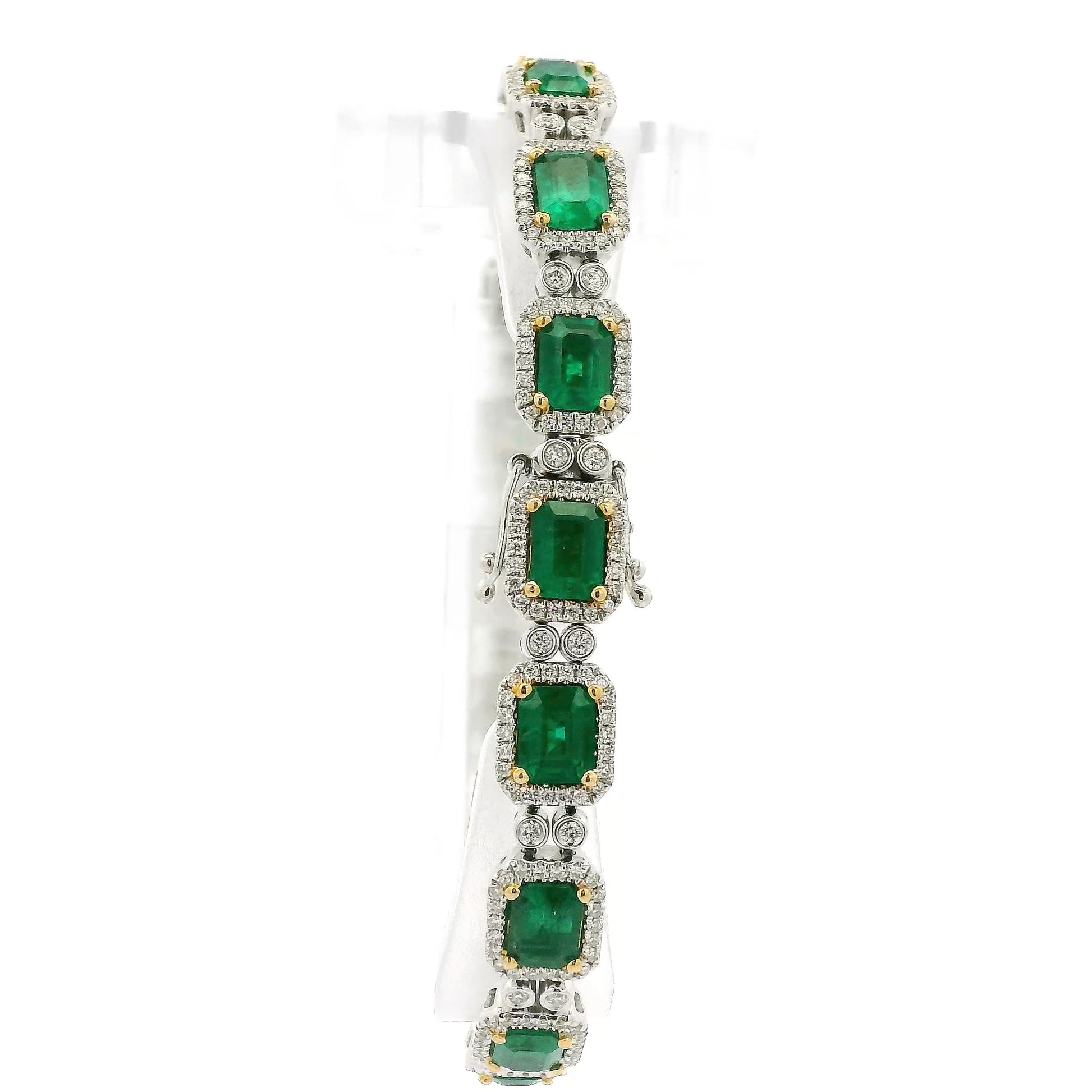 A White Gold Bracelet with prong set emerald cut natural Emeralds in the center with a diamond halo and diamonds between each link at Forever Rox Fine Jewelry, Lake Tahoes Best Jewelry Store