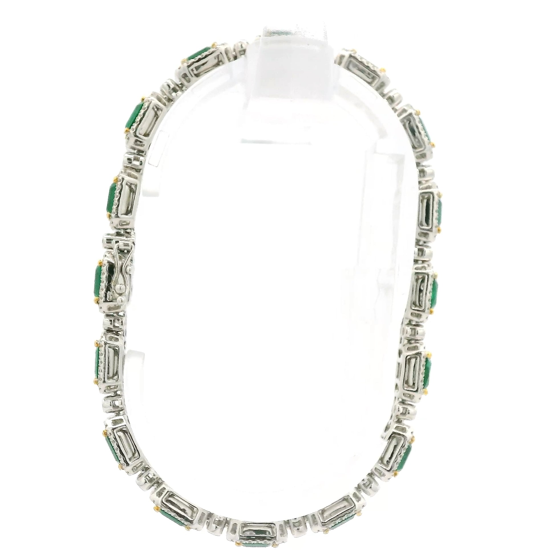 A White Gold Bracelet with prong set emerald cut natural Emeralds in the center with a diamond halo and diamonds between each link at Forever Rox Fine Jewelry, Lake Tahoes Best Jewelry Store