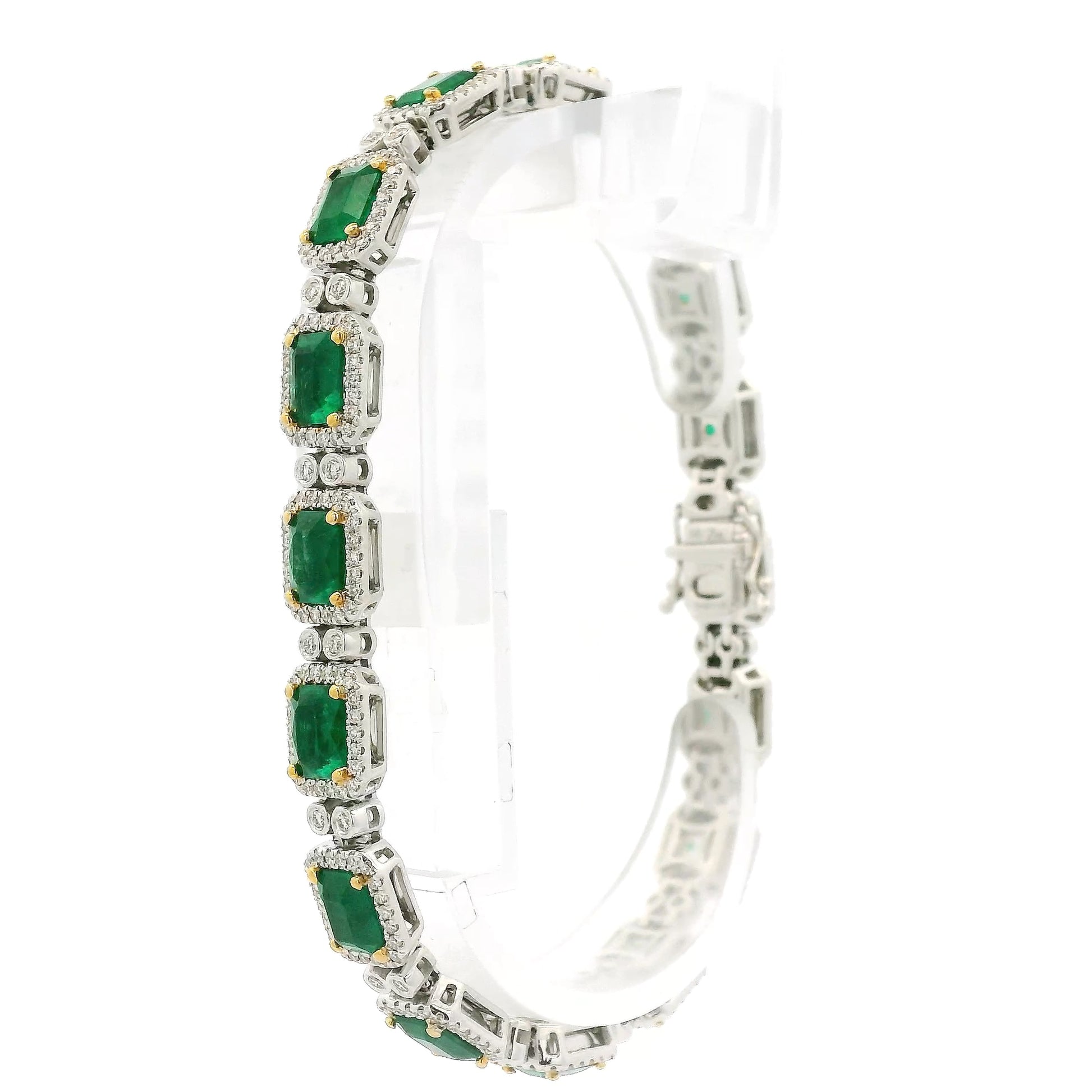 A White Gold Bracelet with prong set emerald cut natural Emeralds in the center with a diamond halo and diamonds between each link at Forever Rox Fine Jewelry, Lake Tahoes Best Jewelry Store