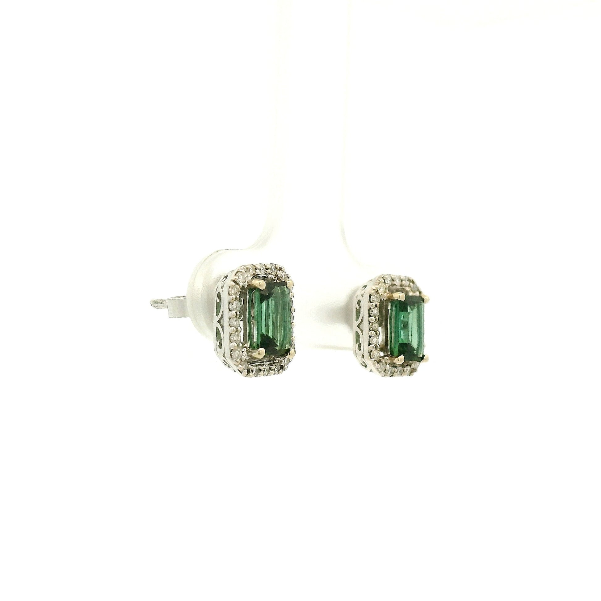 A Pair of White Gold Earrings with prong set emerald cut natural Green Tourmaline in the center with a diamond halo at Forever Rox Fine Jewelry, Lake Tahoes Best Jewelry Store
