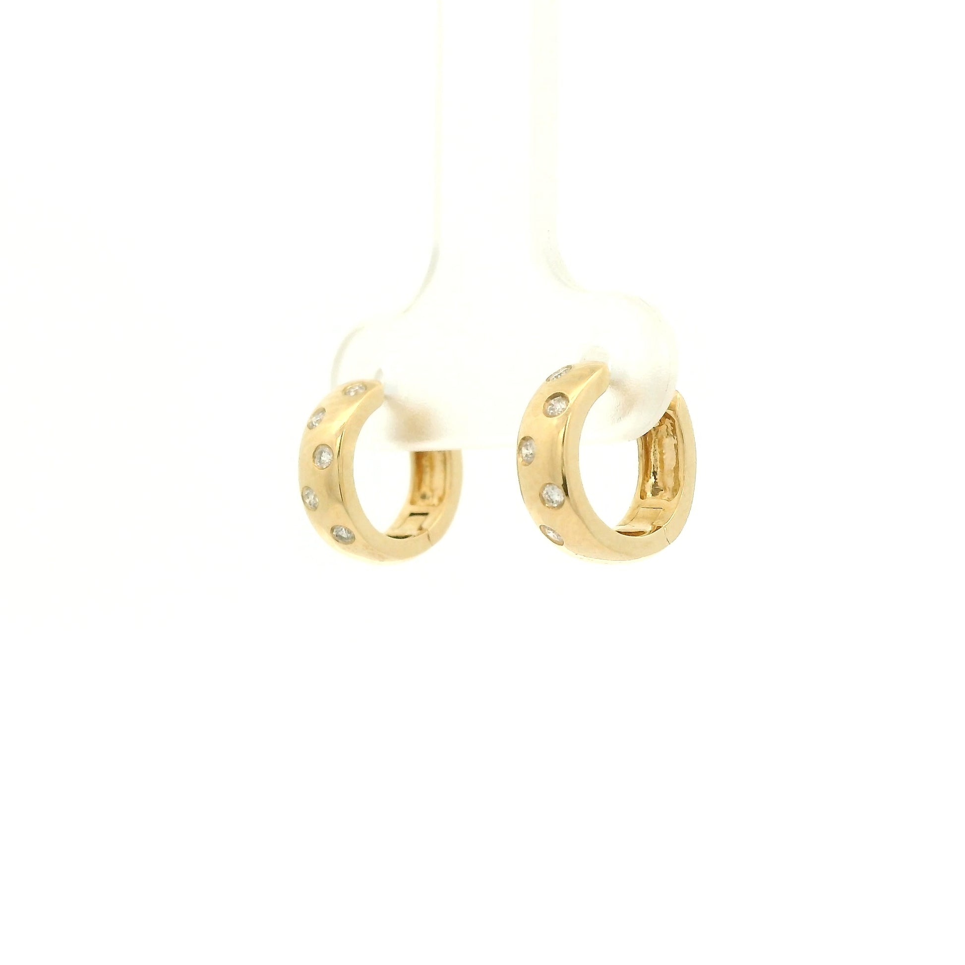 A Pair of Yellow Gold Hoop Earrings with flush set round cut natural Diamonds scattered in the gold at Forever Rox Fine Jewelry, Lake Tahoes Best Jewelry Store