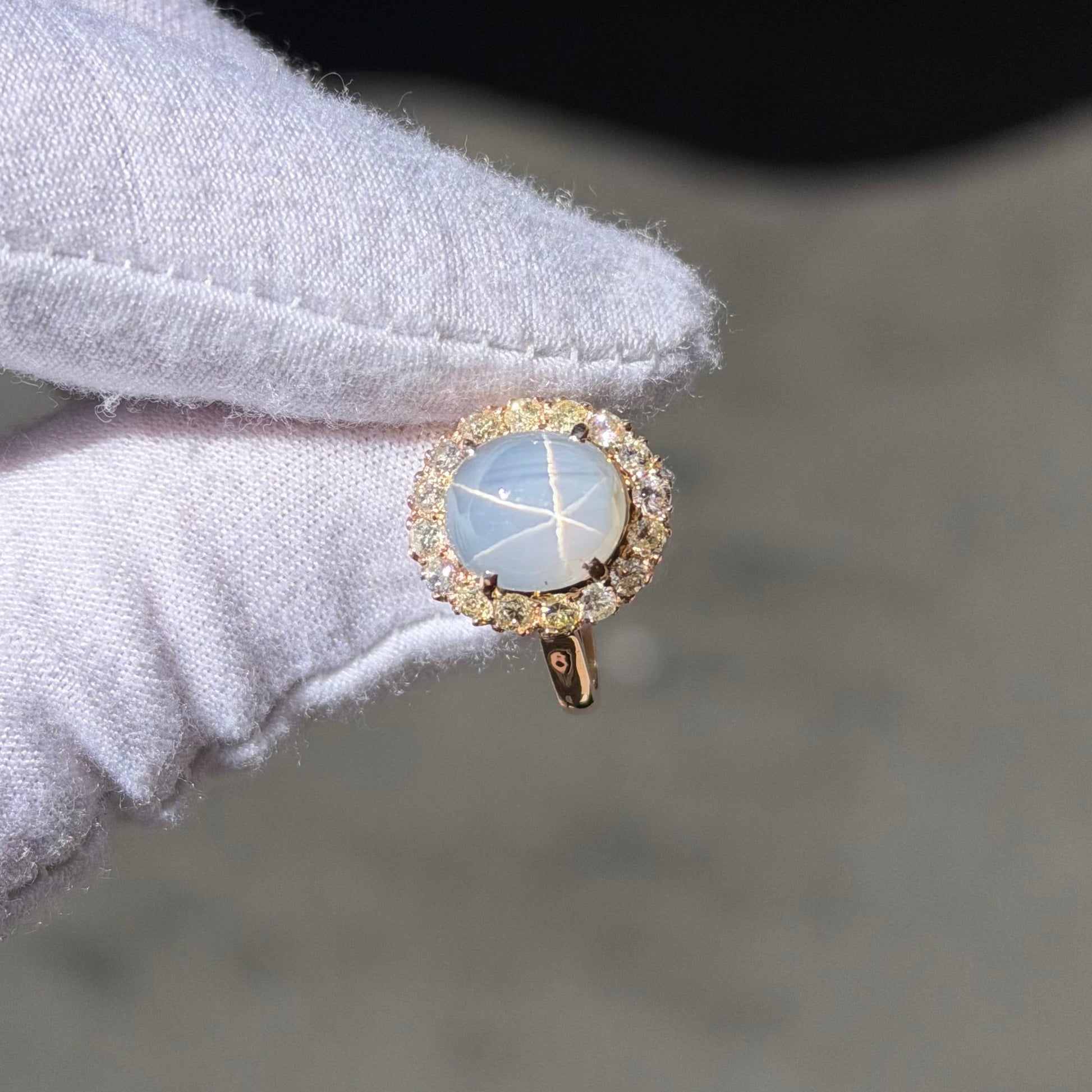 A Rose Gold Ring with a prong set cabochon cut natural Star Sapphire in the center with a diamond halo at Forever Rox Fine Jewelry, Lake Tahoes Best Jewelry Store