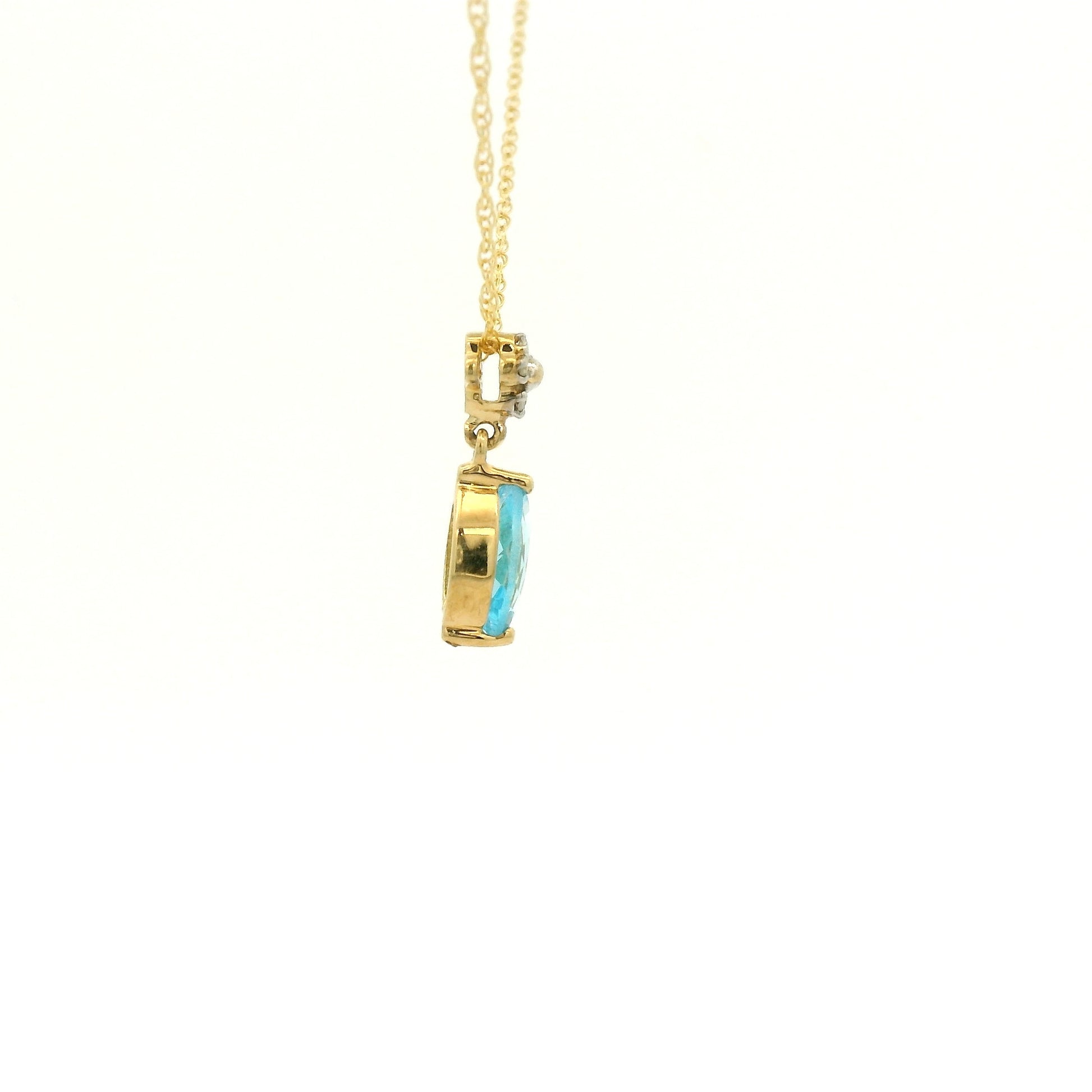 Yellow Gold Pendant with a prong set marquise cut natural Blue Topaz in the center with 4 diamonds at Forever Rox Fine Jewelry, Lake Tahoes Best Jewelry Store
