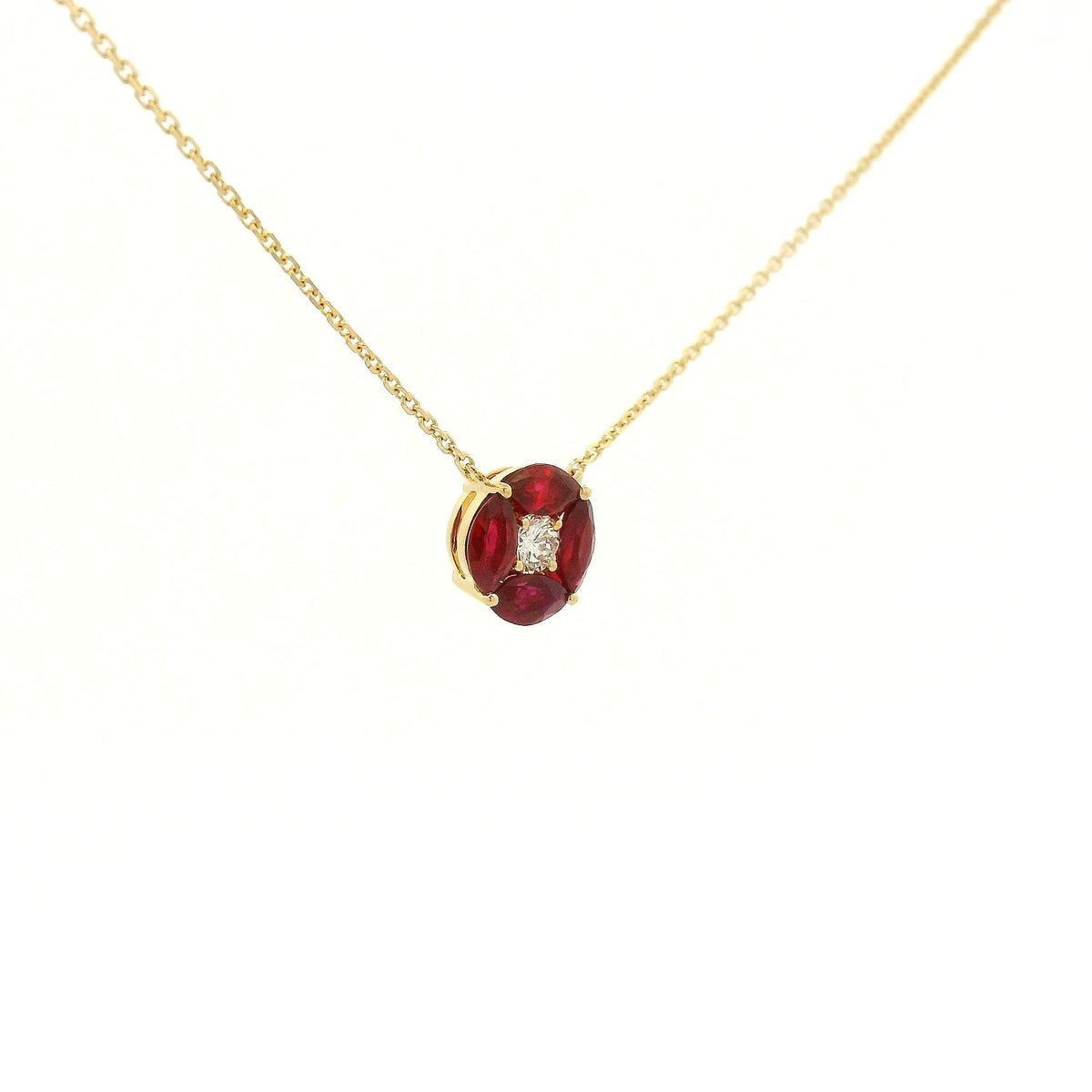 A Yellow Gold Pendant with a round cut diamond in the center & 4 marquise cut rubies in a circle around it at Forever Rox Fine Jewelry, Lake Tahoes Best Jewelry Store