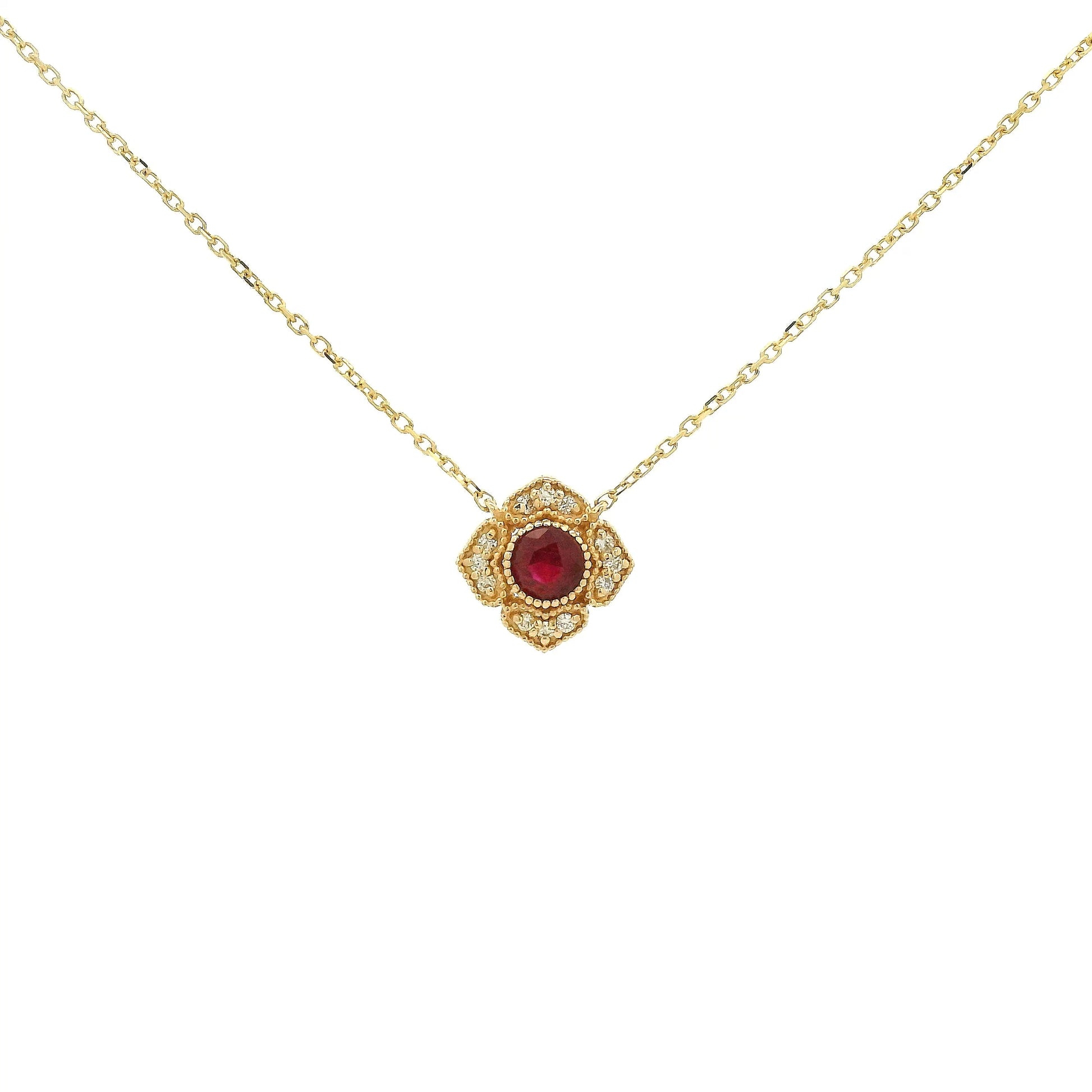 A Yellow Gold Flower Pendant with a milgrain bezel set round cut natural Ruby in the centerand diamonds with a chain attached at Forever Rox Fine Jewelry, Lake Tahoes Best Jewelry Store