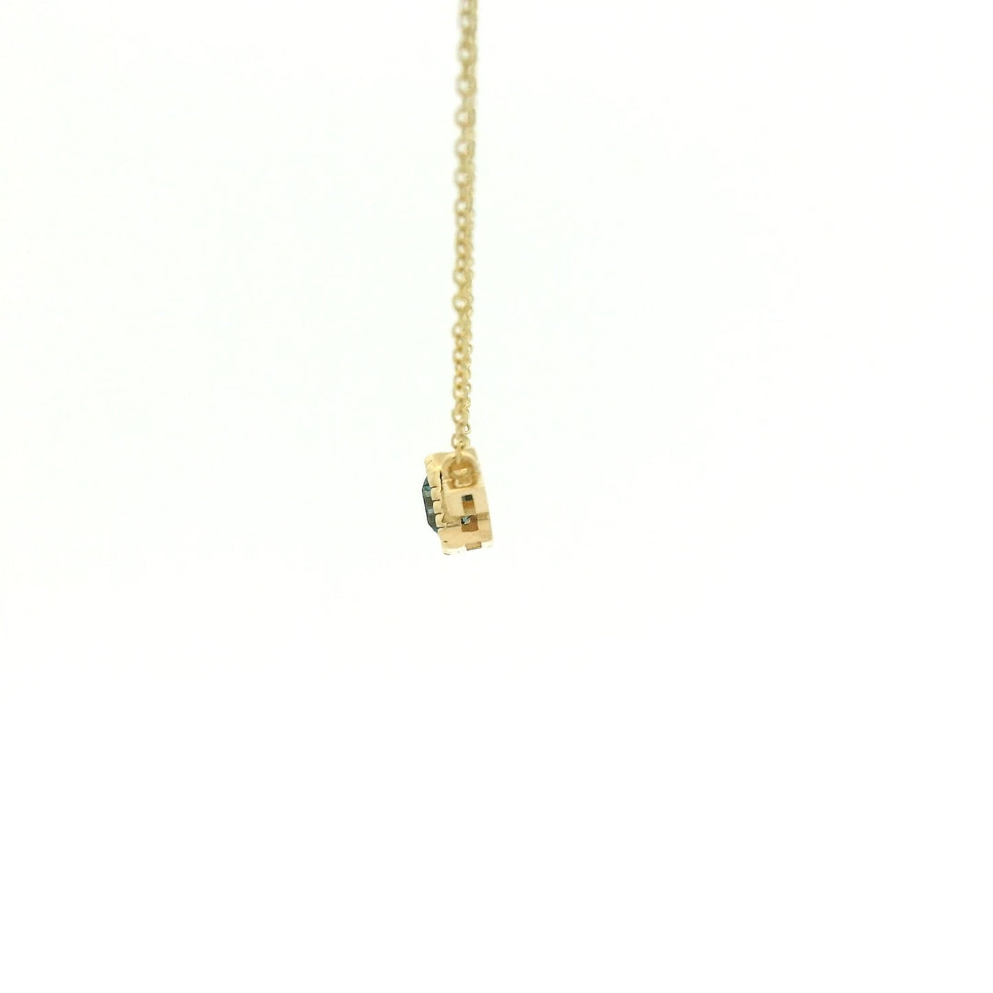 A Yellow Gold Pendant with a milgrain bezel set emerald cut natural London Blue Topaz in the center with 2 diamonds and a chain attached at Forever Rox Fine Jewelry, Lake Tahoes Best Jewelry Store