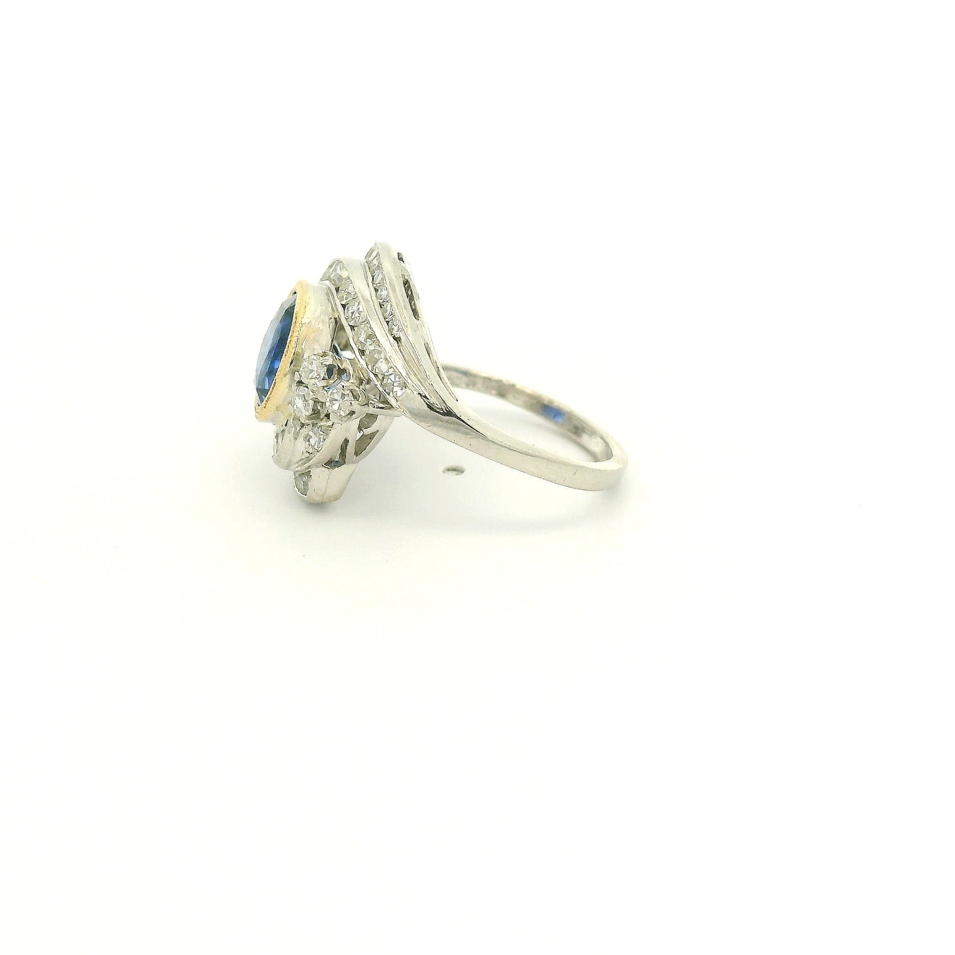 A Vintage Platinum & Yellow Gold Ring with a milgrain bezel set round cut natural Fine Blue Sapphire in the center with diamonds scattered around at Forever Rox Fine Jewelry, Lake Tahoes Best Jewelry Store