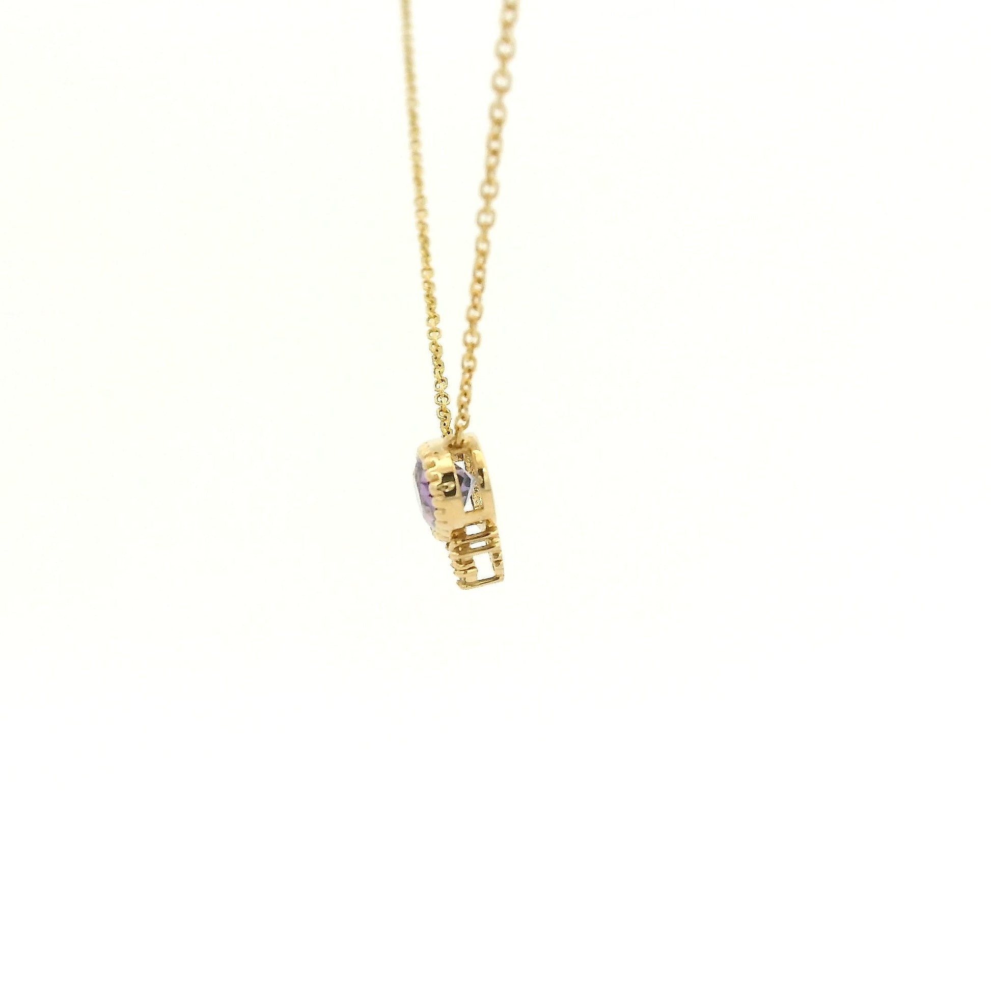 A Yellow Gold Pendant with a milgrain bezel set oval cut natural Amethyst in the center with 3 diamonds and a chain attached at Forever Rox Fine Jewelry, Lake Tahoes Best Jewelry Store