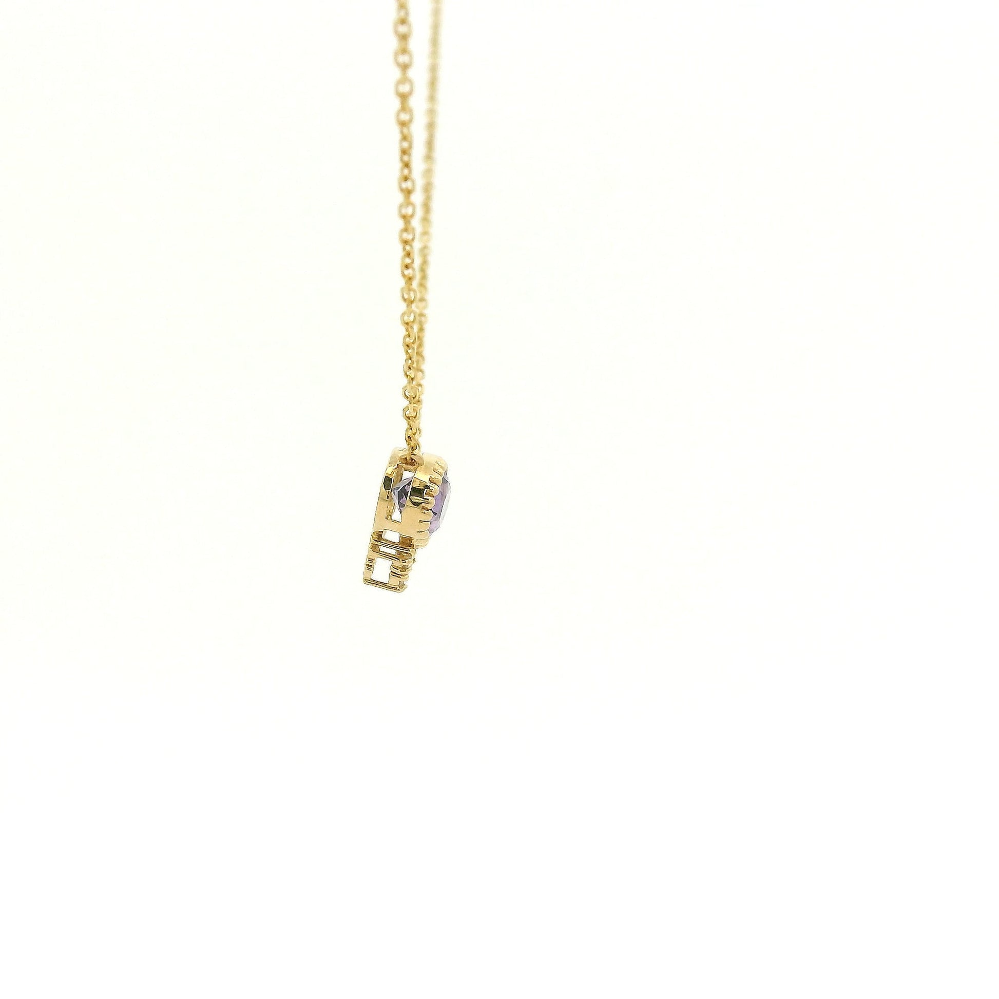 A Yellow Gold Pendant with a milgrain bezel set oval cut natural Amethyst in the center with 3 diamonds and a chain attached at Forever Rox Fine Jewelry, Lake Tahoes Best Jewelry Store