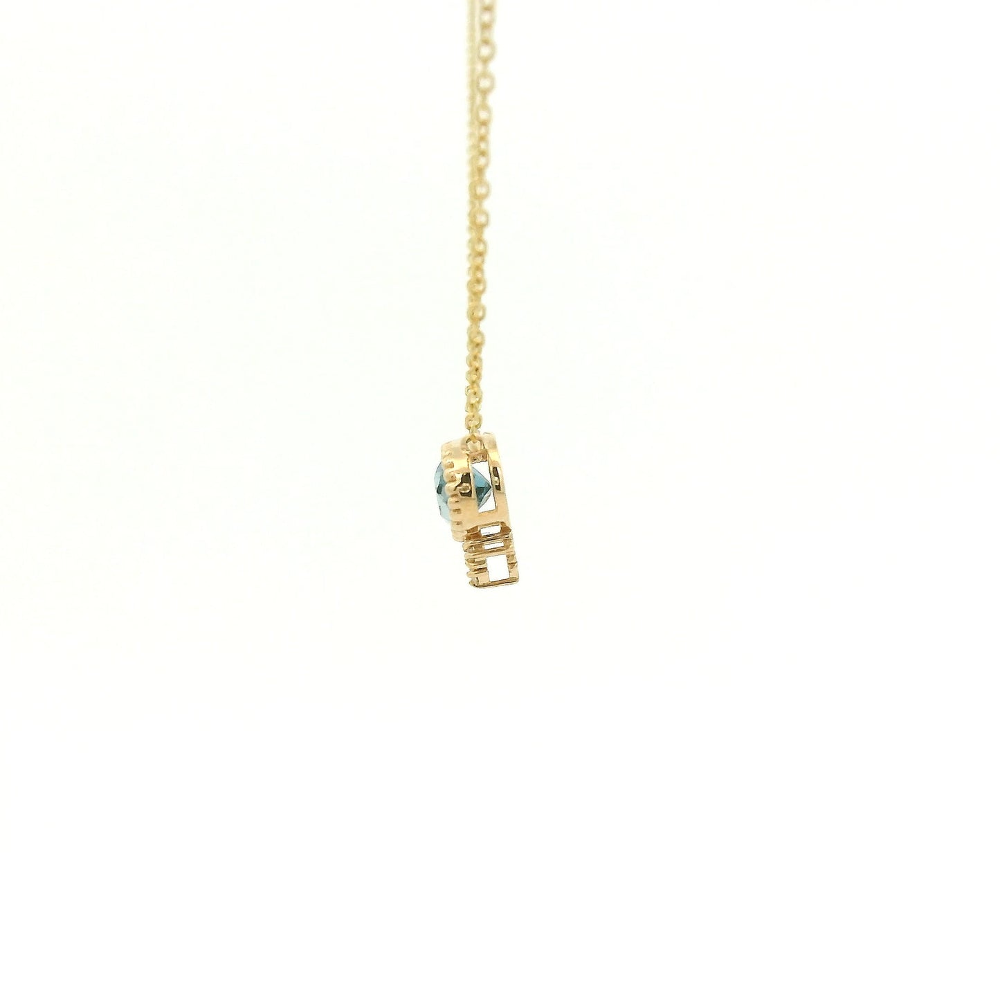 A Yellow Gold Pendant with a milgrain bezel set oval cut natural London Blue Topaz in the center with 3 diamonds and a chain attached at Forever Rox Fine Jewelry, Lake Tahoes Best Jewelry Store