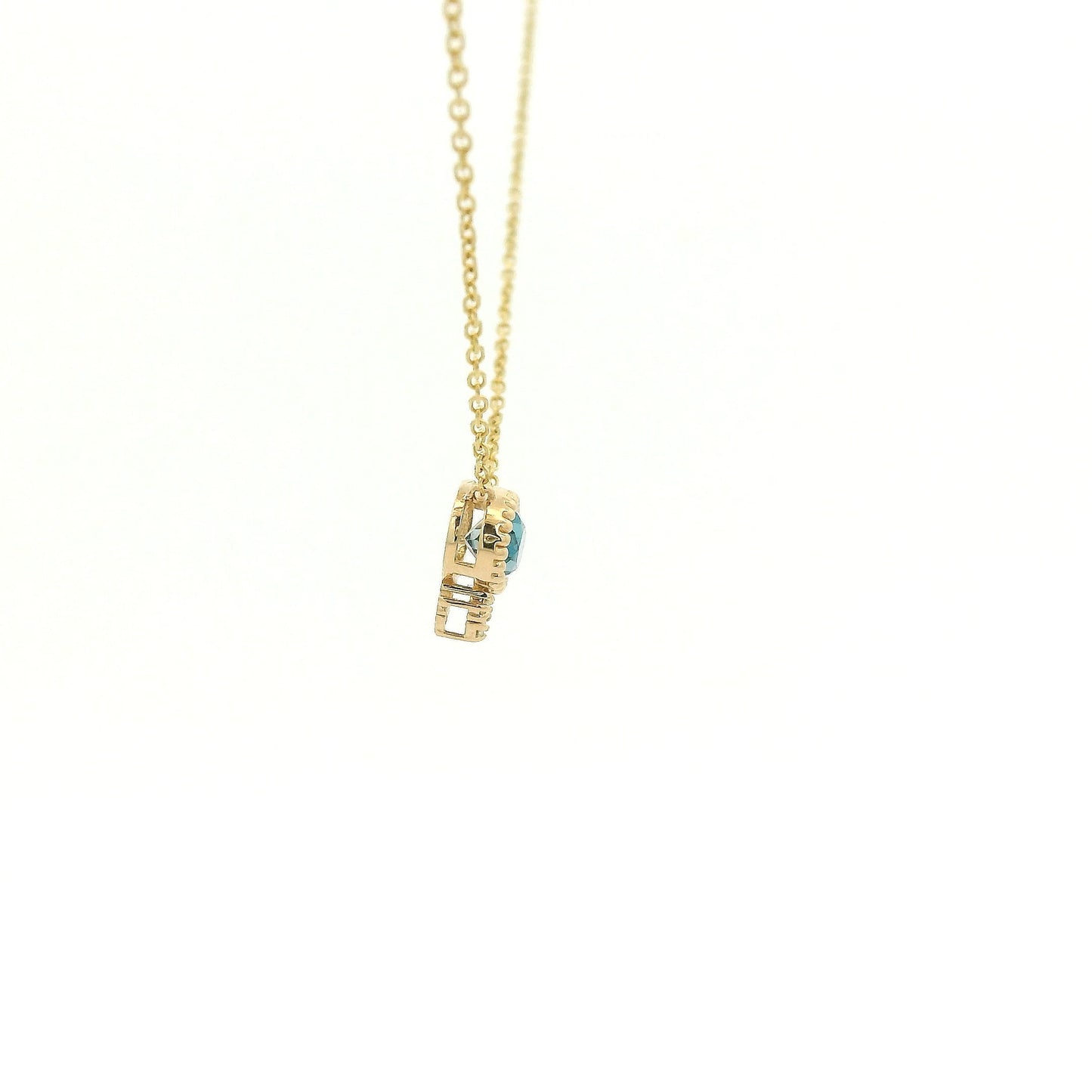 A Yellow Gold Pendant with a milgrain bezel set oval cut natural London Blue Topaz in the center with 3 diamonds and a chain attached at Forever Rox Fine Jewelry, Lake Tahoes Best Jewelry Store