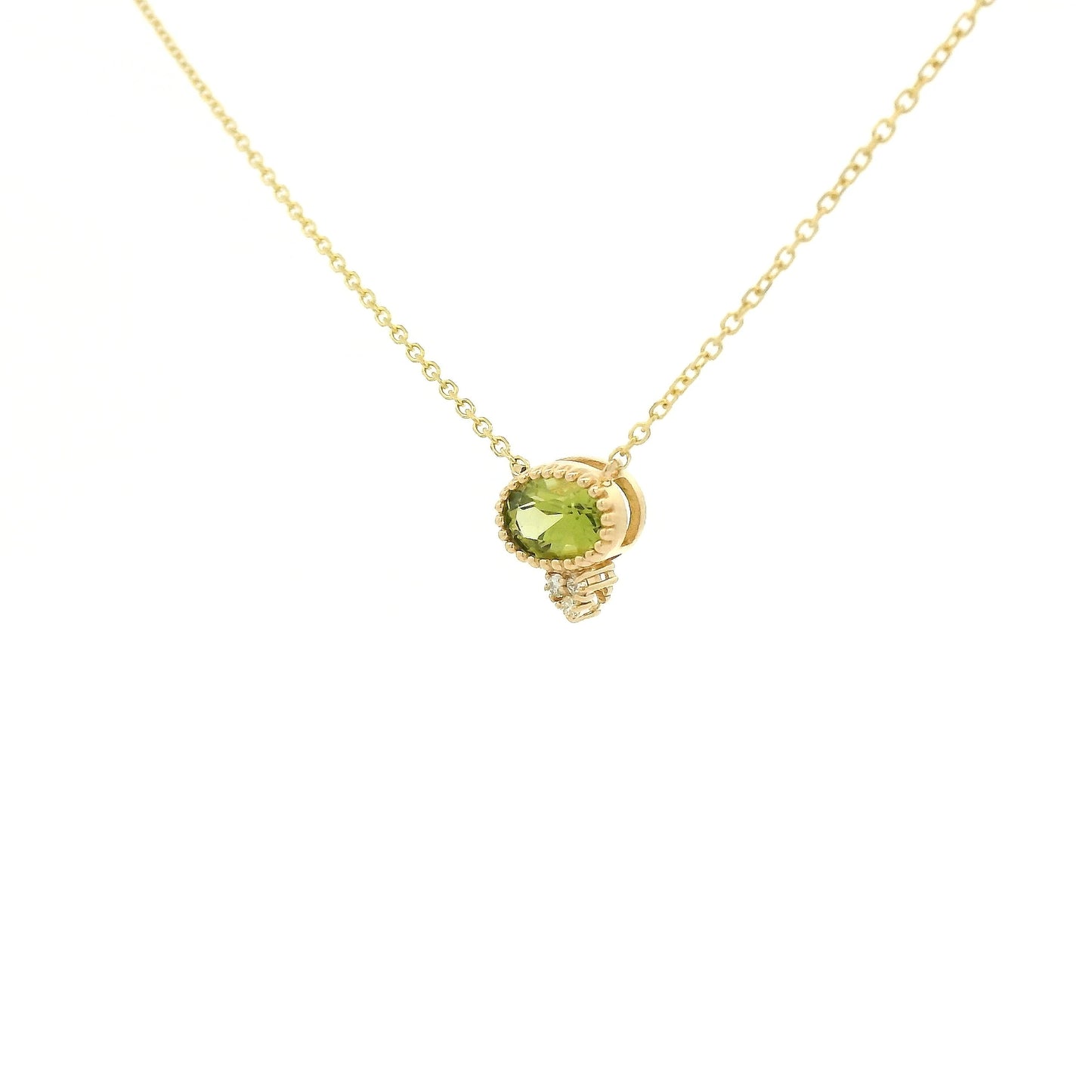 A Yellow Gold Pendant with a milgrain bezel set oval cut natural Peridot in the center with 3 diamonds and a chain attached at Forever Rox Fine Jewelry, Lake Tahoes Best Jewelry Store
