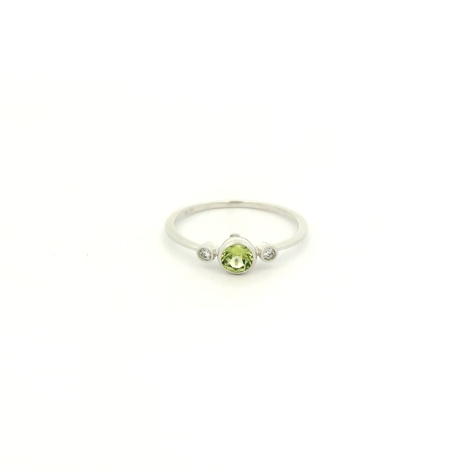 A White Gold Ring with a milgrain bezel set round cut natural Peridot in the center with 2 bezel set Natural Diamonds at Forever Rox Fine Jewelry, Lake Tahoes Best Jewelry Store
