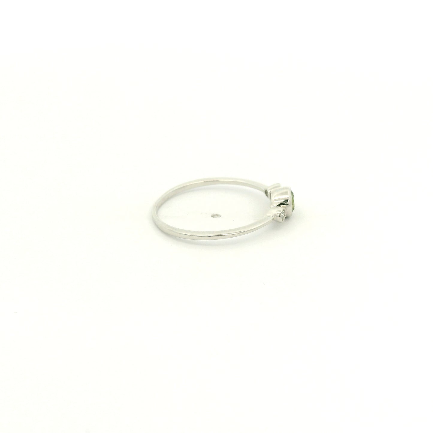 A White Gold Ring with a milgrain bezel set round cut natural Peridot in the center with 2 bezel set Natural Diamonds at Forever Rox Fine Jewelry, Lake Tahoes Best Jewelry Store
