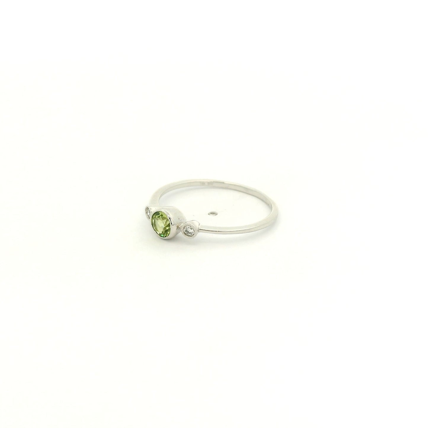 A White Gold Ring with a milgrain bezel set round cut natural Peridot in the center with 2 bezel set Natural Diamonds at Forever Rox Fine Jewelry, Lake Tahoes Best Jewelry Store
