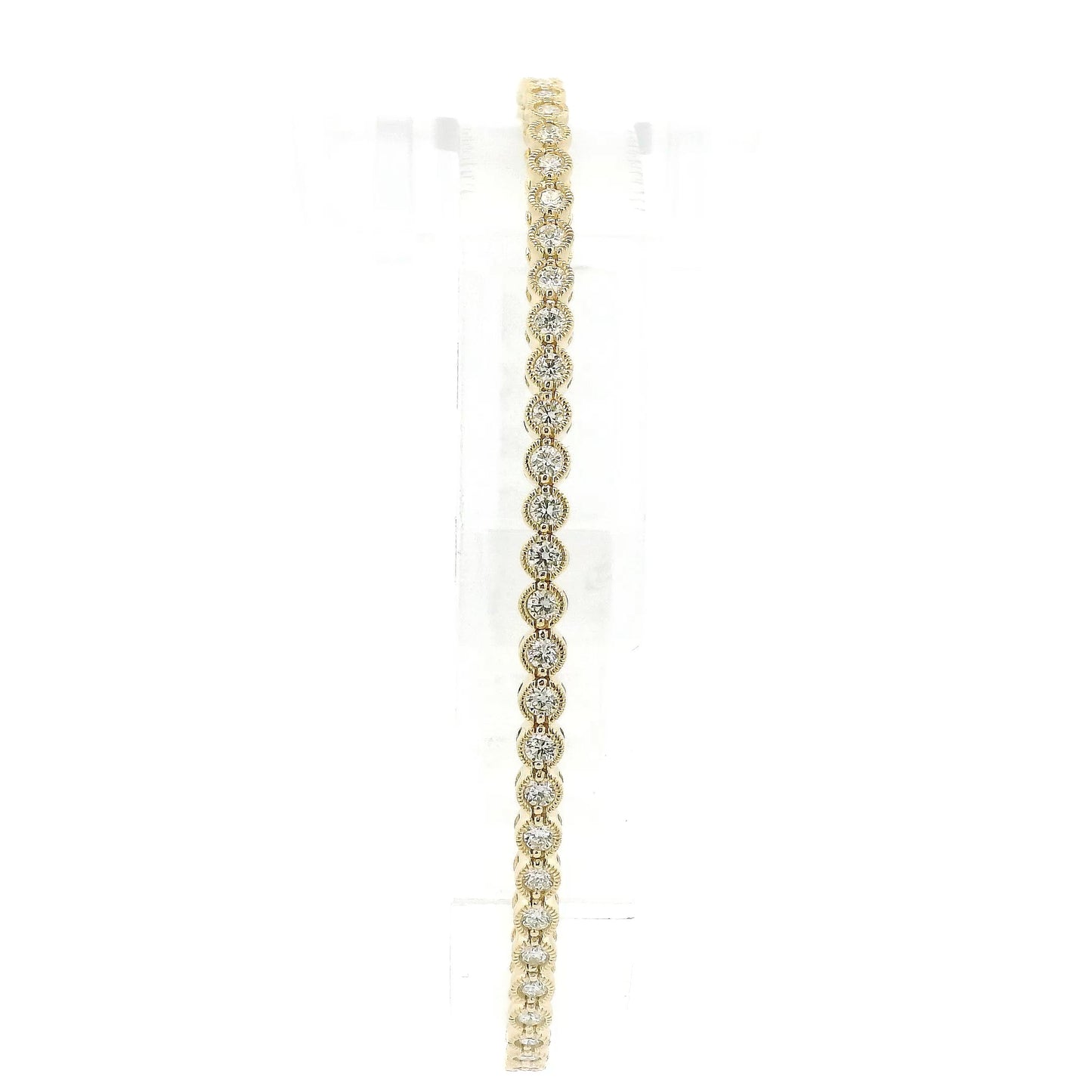 A Yellow Gold Flex Bangle Bracelet with milgrain bezel set round cut natural Diamonds in the center at Forever Rox Fine Jewelry, Lake Tahoes Best Jewelry Store