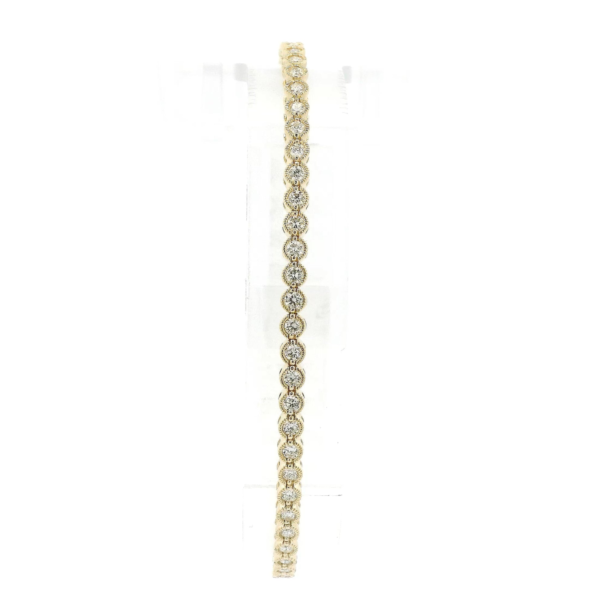 A Yellow Gold Flex Bangle Bracelet with milgrain bezel set round cut natural Diamonds in the center at Forever Rox Fine Jewelry, Lake Tahoes Best Jewelry Store