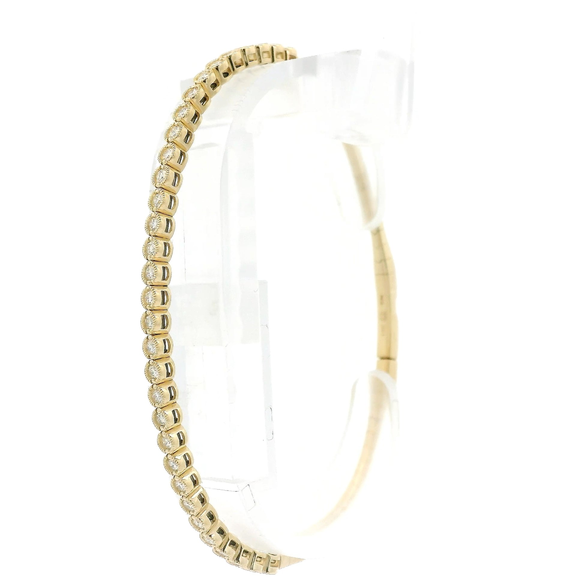 A Yellow Gold Flex Bangle Bracelet with milgrain bezel set round cut natural Diamonds in the center at Forever Rox Fine Jewelry, Lake Tahoes Best Jewelry Store
