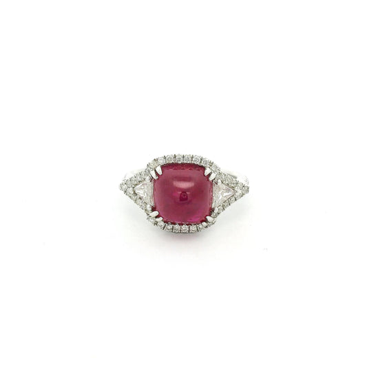 A White Gold Ring with a prong set sugarloaf cabochon GIA Certified natural Ruby in the center with two triangle cut diamonds and round cut diaomonds at Forever Rox Fine Jewelry, Lake Tahoes Best Jewelry Store