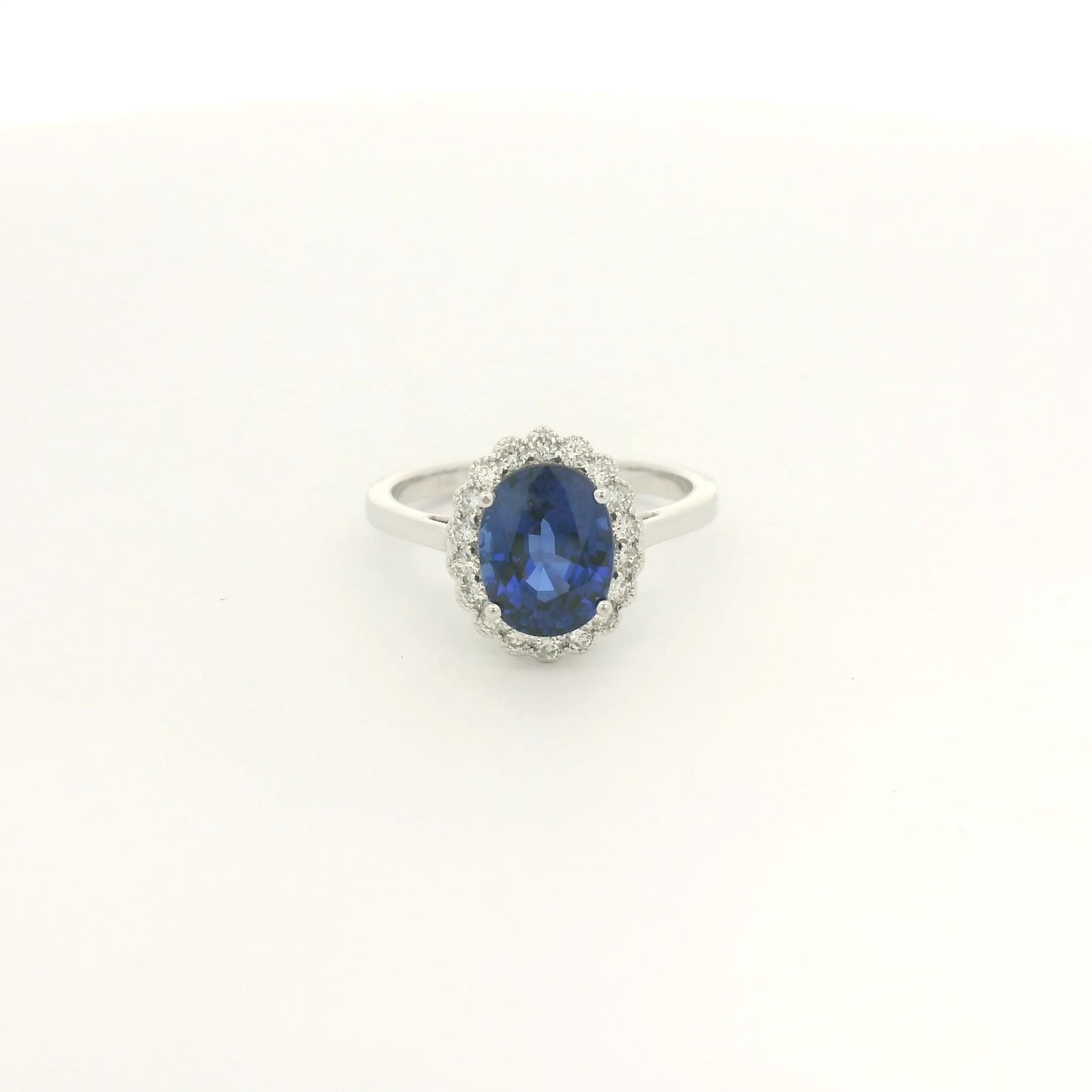 A White Gold Ring with a prong set oval cut natural Ceylon Sapphire in the center with a diamond halo with milgrain at Forever Rox Fine Jewelry, Lake Tahoes Best Jewelry Store