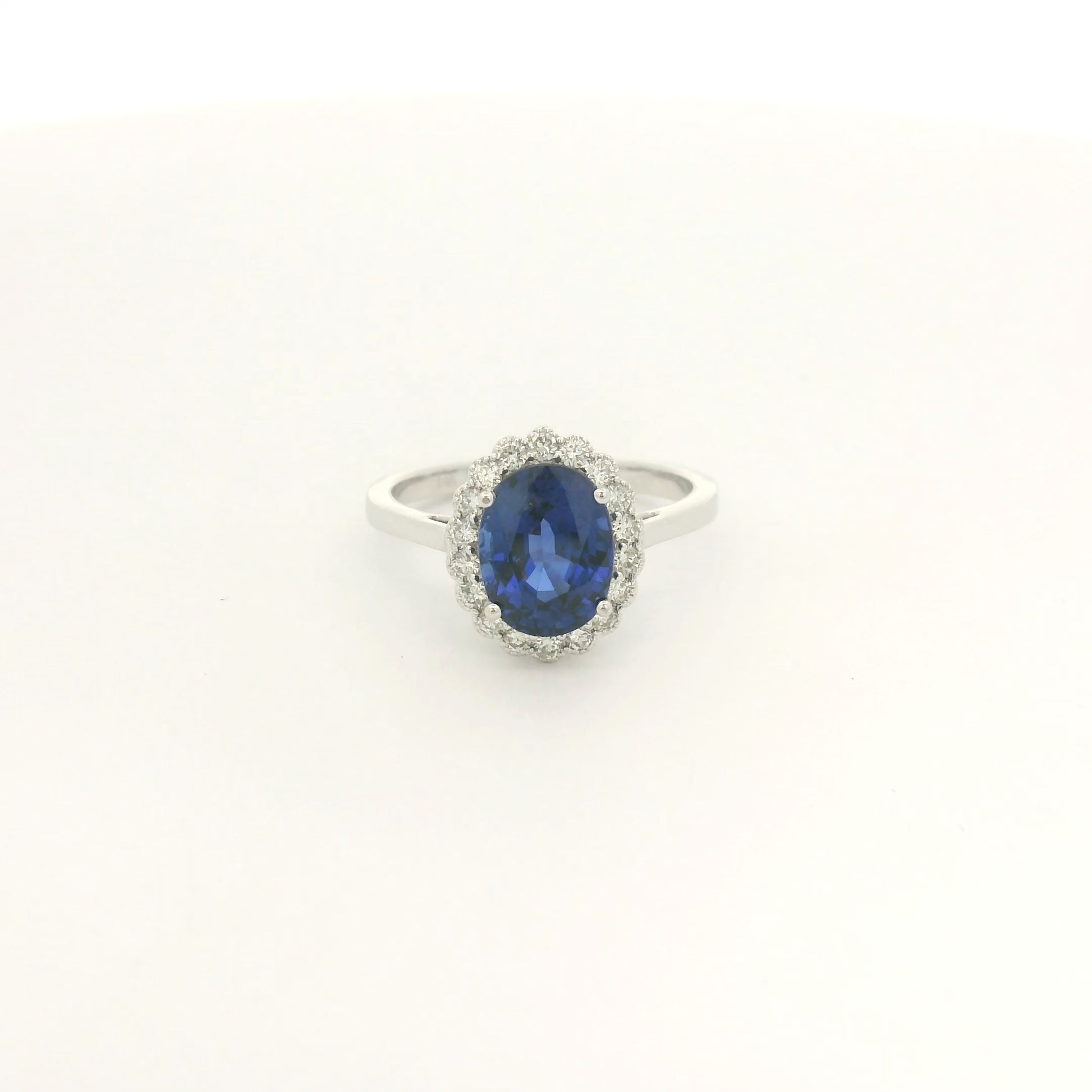 A White Gold Ring with a prong set oval cut natural Ceylon Sapphire in the center with a diamond halo with milgrain at Forever Rox Fine Jewelry, Lake Tahoes Best Jewelry Store
