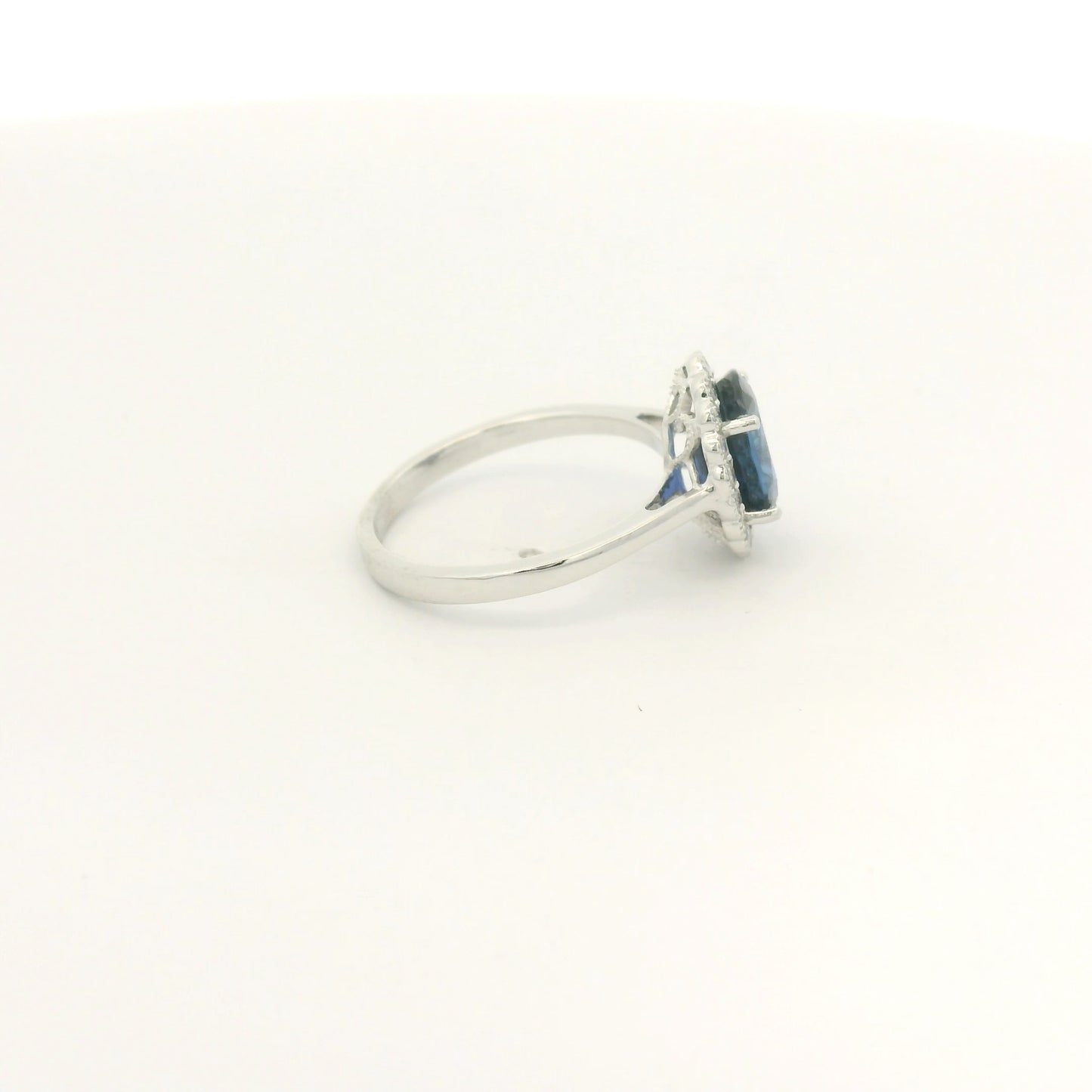 A White Gold Ring with a prong set oval cut natural Ceylon Sapphire in the center with a diamond halo with milgrain at Forever Rox Fine Jewelry, Lake Tahoes Best Jewelry Store