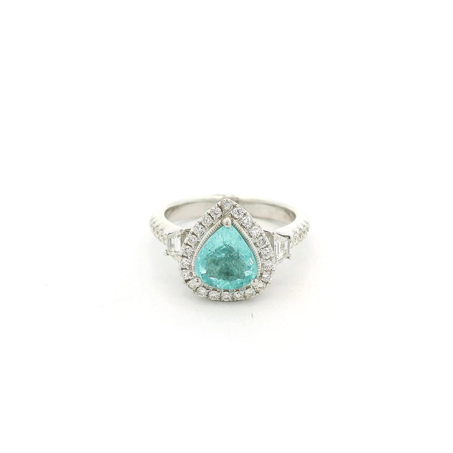 A White Gold Ring with a prong set pear cut natural Paraíba Tourmaline in the center with a halo of round cut diamonds and two trapazoid cut diamonds at Forever Rox Fine Jewelry, Lake Tahoes Best Jewelry Store