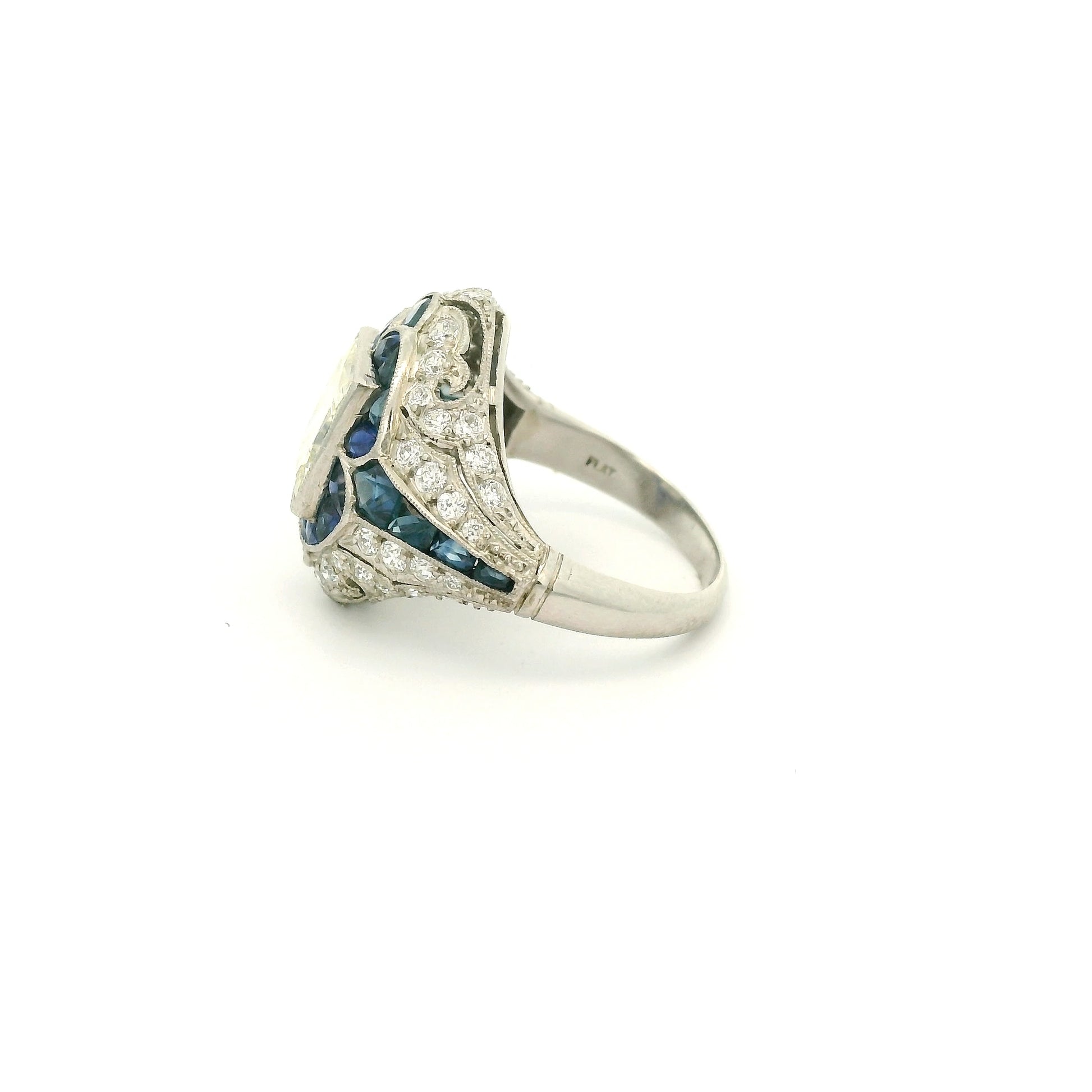 A Platinum Ring with a bezel set princess cut natural Diamond in the center with Sapphire and diamonds all around the ring at Forever Rox Fine Jewelry, Lake Tahoes Best Jewelry Store