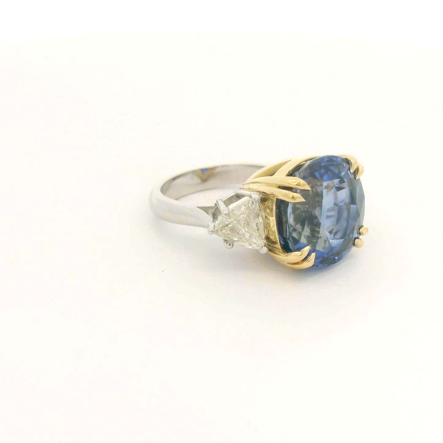 Product #: 69628MU> Stone Weight: 18.95ctw Natural Certified Ceylon Sapphire. Accent Stone: 2.16ctw Natural Trillion Cut Diamonds. Metal: Platinum & 18k Yellow Gold. 
