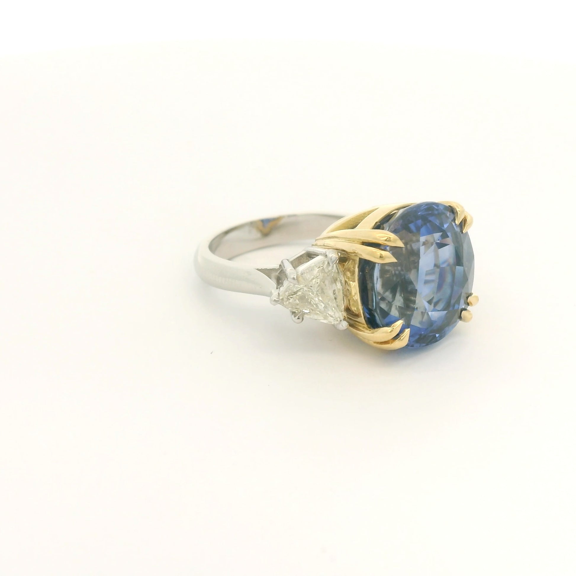 Product #: 69628MU> Stone Weight: 18.95ctw Natural Certified Ceylon Sapphire. Accent Stone: 2.16ctw Natural Trillion Cut Diamonds. Metal: Platinum & 18k Yellow Gold. 