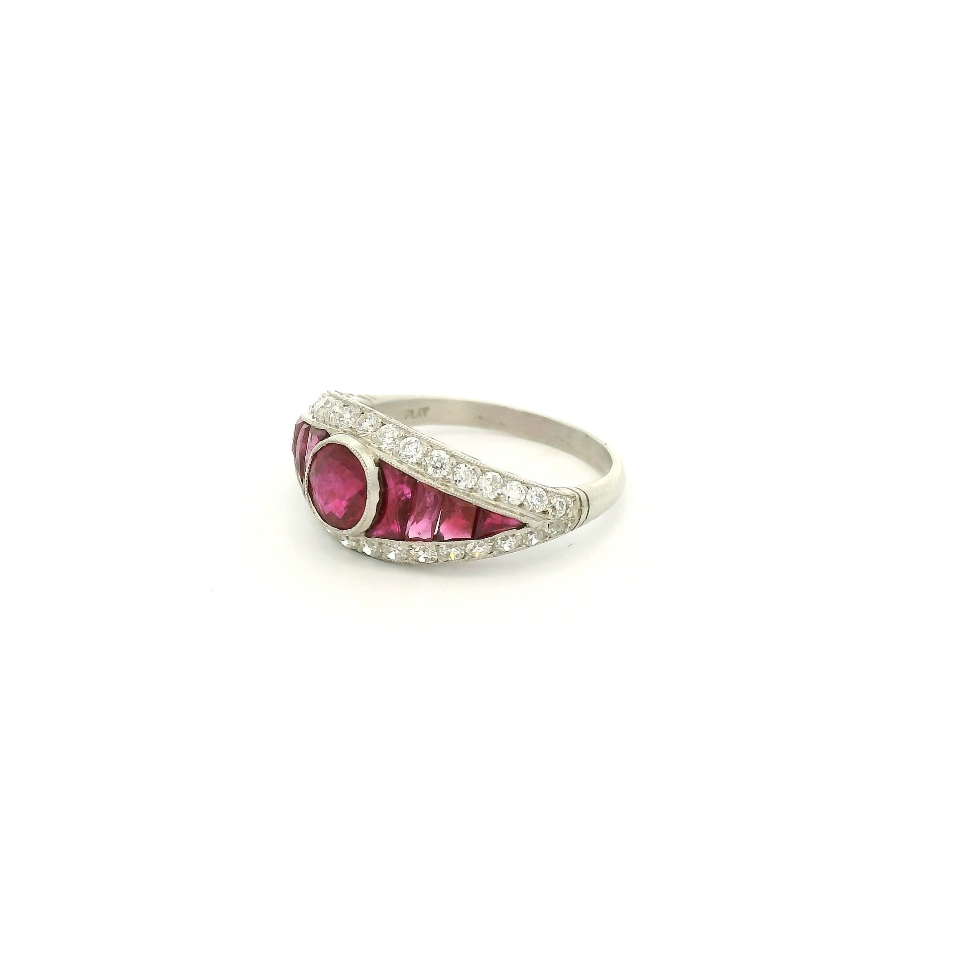 A Platinum Ring with a bezel set round cut natural Ruby in the center with baguette cut rubies and diamonds at Forever Rox Fine Jewelry, Lake Tahoes Best Jewelry Store