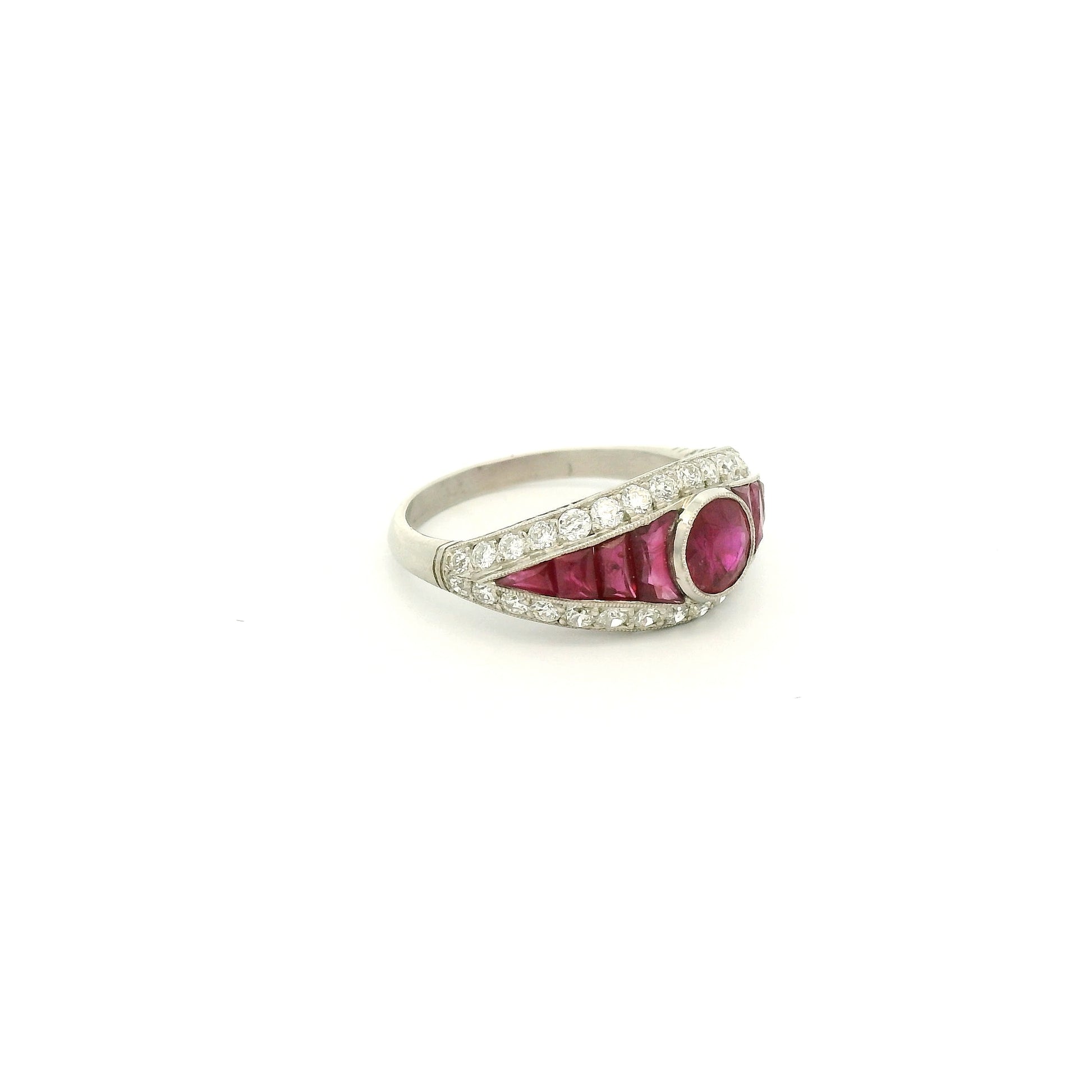 A Platinum Ring with a bezel set round cut natural Ruby in the center with baguette cut rubies and diamonds at Forever Rox Fine Jewelry, Lake Tahoes Best Jewelry Store