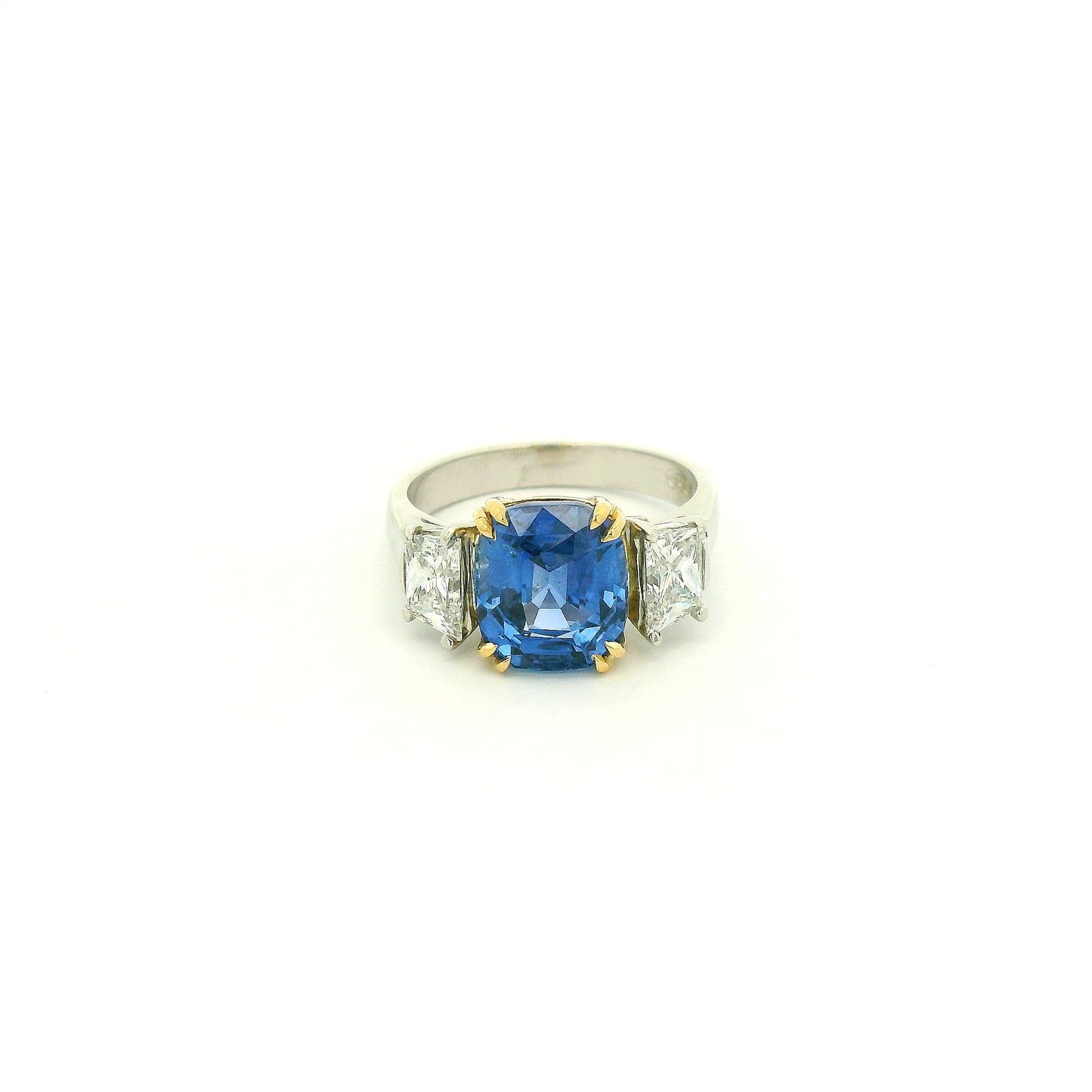 A Platinum & Yellow Gold Ring with a prong set natural TGC Certified No Heat Cushion Cut Cornflower Blue Sapphire & 2 Trapazoid Cut Diamonds at Forever Rox Fine Jewelry, Lake Tahoes Best Jewelry Store