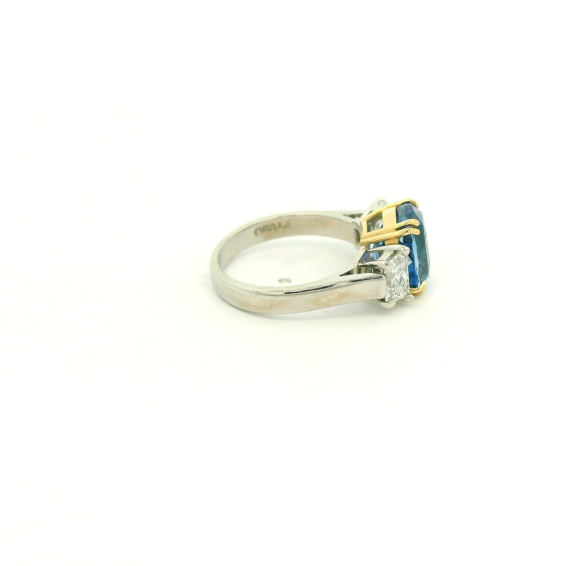 A Platinum & Yellow Gold Ring with a prong set natural TGC Certified No Heat Cushion Cut Cornflower Blue Sapphire & 2 Trapazoid Cut Diamonds at Forever Rox Fine Jewelry, Lake Tahoes Best Jewelry Store
