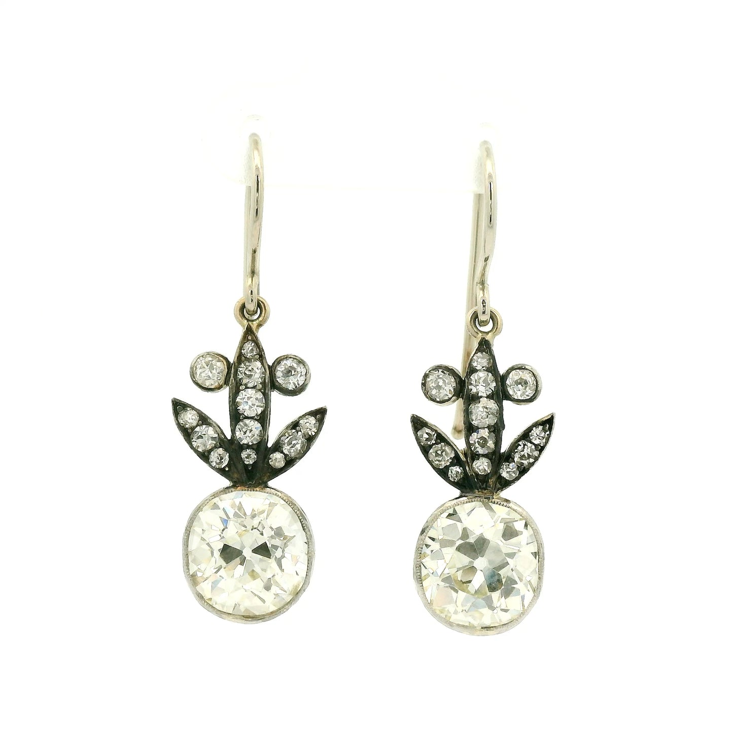 A Pair of White Gold Victorian Dangle Earrings with bezel set old mine cut natural Diamonds in the center with diamonds dangling down at Forever Rox Fine Jewelry, Lake Tahoes Best Jewelry Store
