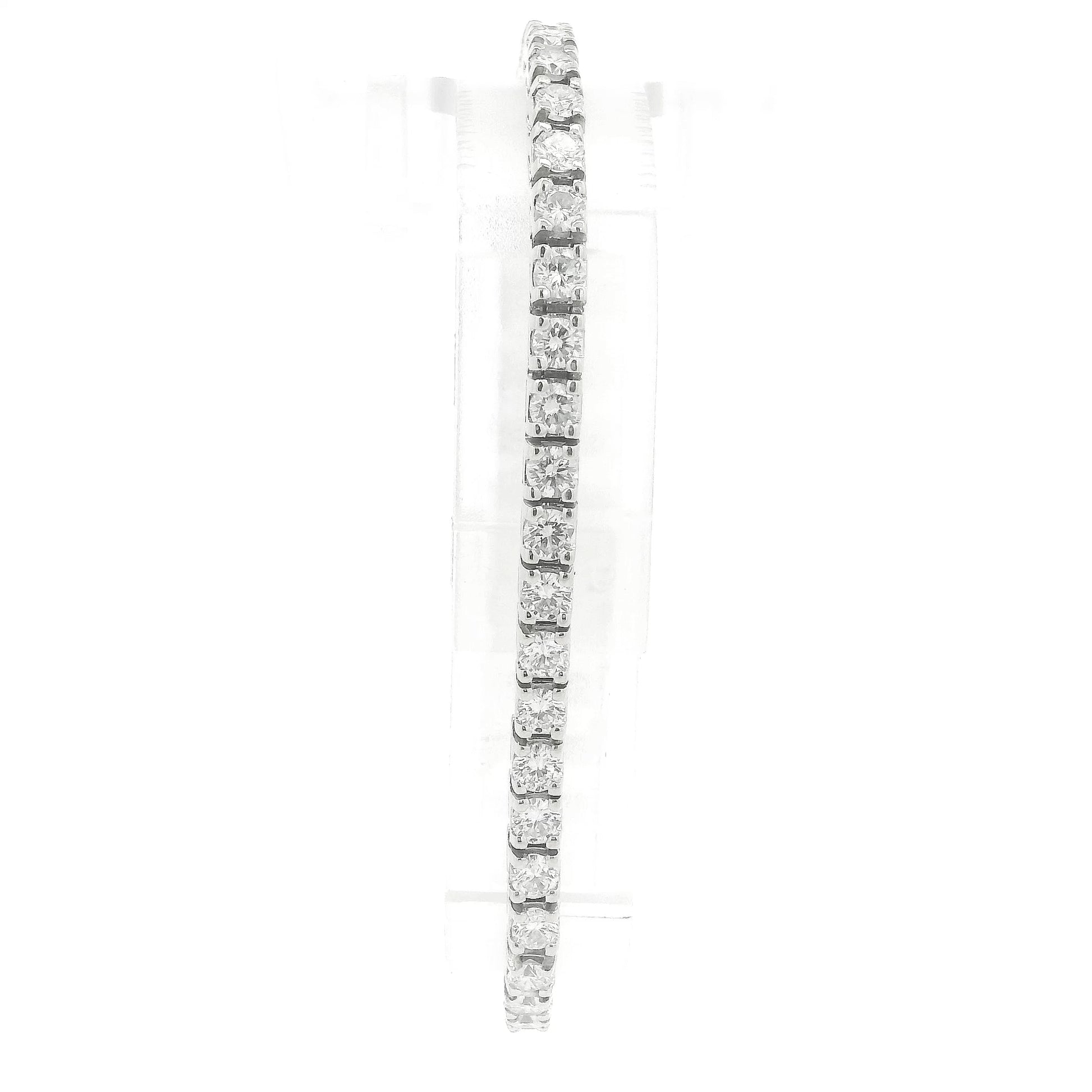 A single white gold diamond tennis bracelet displayed vertically on a clear stand against a plain white background at Forever Rox Fine Jewelry, Lake Tahoes Best Jewelry Store