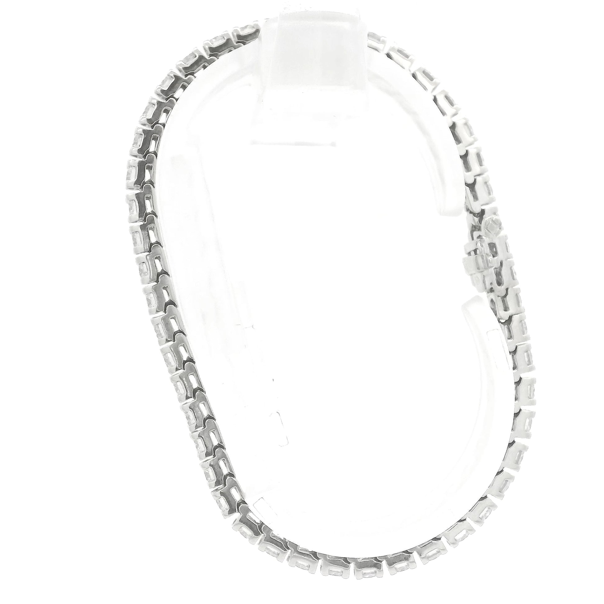 A single white gold diamond tennis bracelet displayed vertically on a clear stand against a plain white background at Forever Rox Fine Jewelry, Lake Tahoes Best Jewelry Store