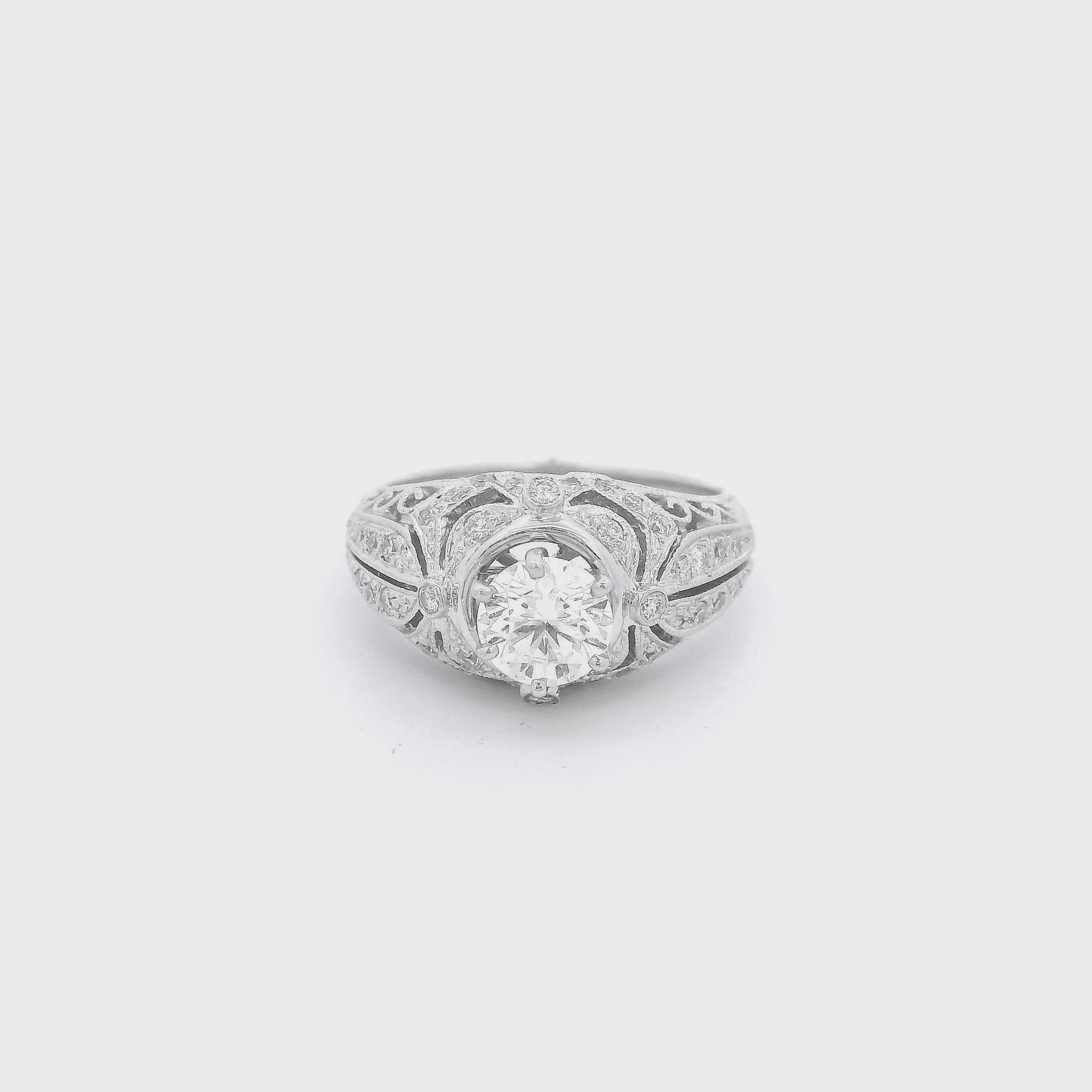 White Gold ring with a round cut diamond set in the cetner and some diamond accents on the filigree hand carved ring at Foreever Rox Fine Jewelry